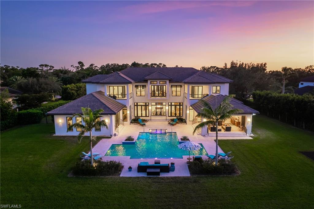 Welcome to 119 Carica Rd, where architectural grandeur meets serene lakefront living. This custom-built masterpiece, erected in 2016, stands proudly on a premium 1-acre lot, epitomizing unparalleled quality and design. The moment you step foot onto the property, you're greeted by a sight to behold. Drenched in natural light, the transitional-style residence boasts panoramic water views, seamlessly blending indoor and outdoor living. Marvel at the infinity-edge pool, a focal point visible from nearly every room, inviting you to unwind in luxury. Spread across the spacious floorplan are 5 bedrooms and six bathrooms, ensuring ample space for privacy and opulence. Entertainment knows no bounds with a dedicated movie theater and a den, perfect for intimate gatherings or quiet reflection. For the automotive enthusiast, a split four-car garage provides optimal storage and convenience. The heart of the home lies in the chef-inspired kitchen, outfitted with top-of-the-line Wolf and Sub-Zero appliances, catering to even the most discerning tastes. Outside, a sprawling outdoor dining and lounge area beckons, complemented by the pristine pool and spa, offering breathtaking views of Warbler Lake. Adding to its appeal, this home represents the lowest price per square foot in all of Pine Ridge, making it an extraordinary value. Whether you seek relaxation or stylish entertainment, this residence promises the epitome of lakeside living. Indulge in the ultimate expression of luxury and elegance at 119 Carica Rd—where every detail speaks to a life well-lived. Welcome home to your personal sanctuary.