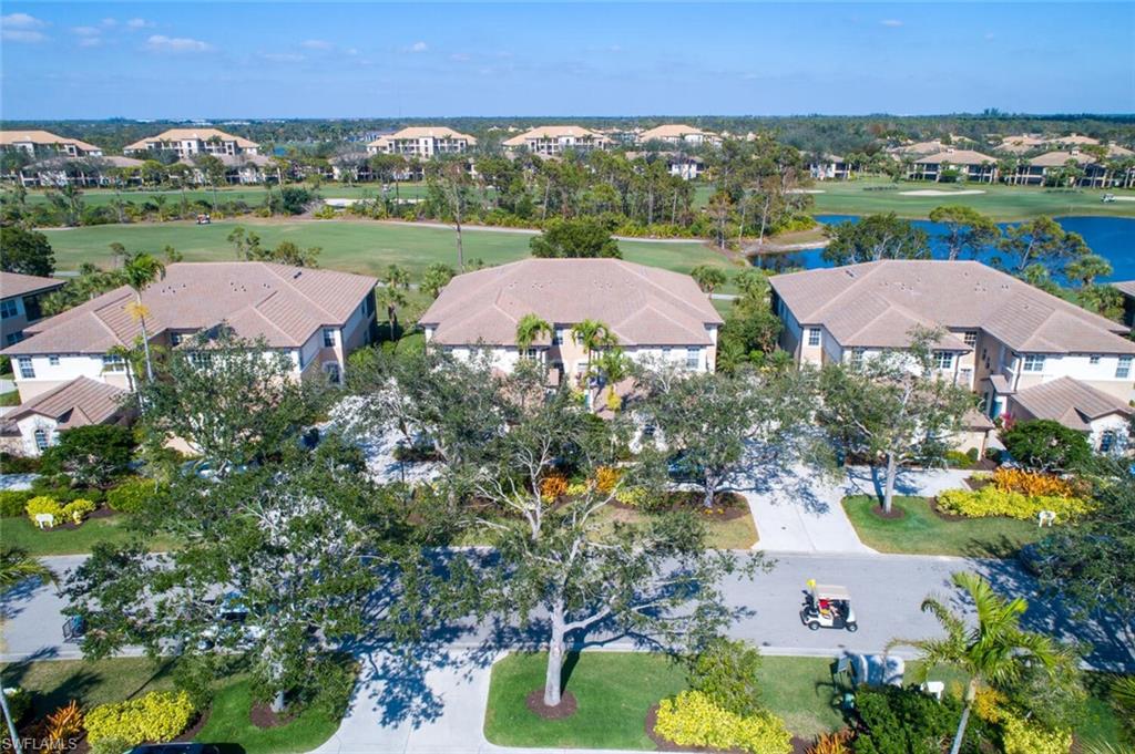 This lovely and rarely available 1st Floor Carriage Home is located just off the 3rd hole of the Sound Course. Enjoy wonderful views of the lake, wildlife and golfers as you relax on this spacious wrap around lanai.  Lexan sliders have been added to the lanai turning this area into an all season room. This home offers 3 bedrooms/2 baths and a 2 car garage, perfect for your car and a golf cart. The spacious great room, kitchen and dining area offers an open floor plan, with stackable sliders onto the lanai for comfortable entertaining! There are numerous upgrades from laminate wood flooring, recently remodeled Master bath and so much more! Pelican Sound Golf & River Club is one of the finest bundled golf communities West of Route 41, with 27 holes of golf, racquet center with 10 pickleball and 8 tennis courts. Boating, kayaking and canoeing is available via the Estero River. There is dry boat storage area within the community. Located only minutes to shopping, restaurants, medical offices, hospitals and 18 minutes to SWFL International Airport. If you are looking for an active lifestyle look no further!!