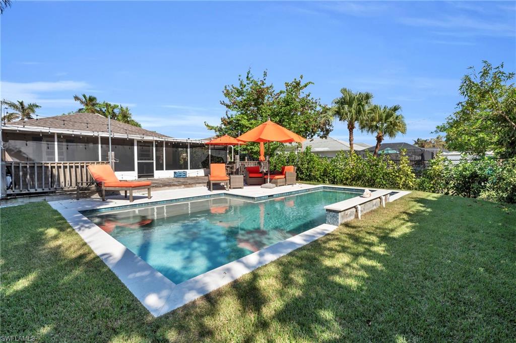 Incredible Pool Home Opportunity in Naples Park, 3 bedrooms (could easily be 4 bedrooms or 3 bedrooms with a garage) including a primary bath with an en suite bath, 2 full baths and a gorgeous pool with a sun shelf. The large fenced in yard has plenty of patio area for lounging in the sun and a screened in covered lanai area as well. High and dry with no flooding this home is easily accessible to the beach, walkable to dining and just across from Mercato for shopping, dining and nightlife. West of 41, this home is perfect for year round or seasonal living and with no HOA or rental restrictions could be a great Short Term Rental Airbnb opportunity to offset the cost.  Newer roof and all impact windows. Paint and furnishings, savvy investor would have instant built in equity. Invest in your future, inquire today.