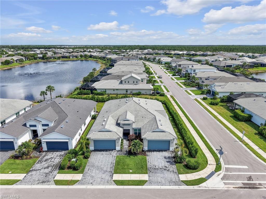 This highly upgraded 2BR + den villa in Azure at Hacienda Lakes has been very lightly lived in and shows like a model home!  This beautifully maintained home features elegant wood flooring, a spacious open floor plan, and a chef’s kitchen designed for both everyday living and entertaining. The den provides flexible space for a home office, guest area, or hobby room and is large enough to be used as a bedroom if needed.  There are many upgrades throughout including designer window coverings, lighting and fans, quartz counters and more!   There's plenty of room for a pool or an extended lanai!   Enjoy a peaceful private view from the main living areas and outdoor space, creating the perfect setting to relax and unwind.  Azure at Hacienda Lakes is a popular resort style community that offers a huge pool with cabanas, state of the art fitness center, library, card room, tennis, pickleball and a large clubhouse with an active social calendar.  This is the perfect opportunity to start enjoying the Florida lifestyle you deserve!