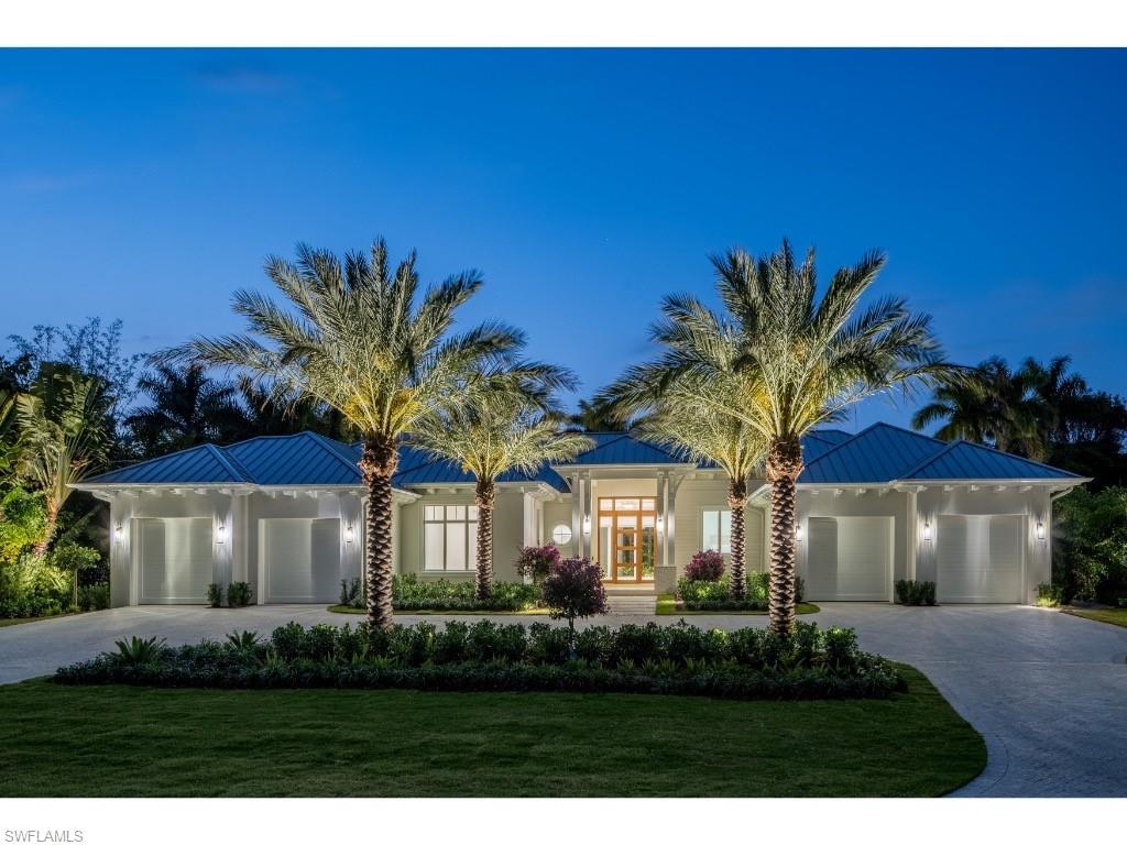 Nestled on one of the most desirable and least-traveled streets in Coquina Sands, this newly completed residence expertly constructed by Coleman Companies and tastefully furnished by Clive Daniel Home offers a rare opportunity to own a refined, single-level estate in the heart of Naples. Set on a substantial homesite, one of the hallmarks of this coveted neighborhood, the property delivers both privacy and expansive indoor-outdoor living. Spanning approximately 5,047 square feet under air, the home features four bedrooms plus a club room/den, all thoughtfully designed on one level. Architectural elements such as tabby mortar, extensive millwork and wood detail, wide-plank wood flooring, and transom windows complement the home’s clean lines and abundant natural light. The great room serves as the centerpiece, seamlessly connecting to the outdoors and creating an effortless flow for entertaining. The well-appointed kitchen features dual islands, Ruffino cabinetry, and is complemented by a large butler’s pantry with impressive supplemental refrigeration, appliances and storage, ideal for hosting. Outdoor living is equally impressive, with a covered lanai featuring a fireplace, outdoor kitchen and bar, and a spacious dining area. The expansive backyard includes an extraordinarily large pool, abundant deck area for outdoor activities, a firepit, and lush green space, offering a truly private retreat.  Additional highly sought after highlights include four garage bays, generator, circular driveway, dual washer/dryer laundry room, outdoor shower, and a finished floor elevation of 14’ (per elevation certificate). Ideally located near the beaches of Naples and Lowdermilk Park, as well as the dining, shopping, and cultural offerings of downtown Naples, and in close proximity to the Four Seasons Resort Naples Beach Club, this residence embodies the very best of the Naples lifestyle.