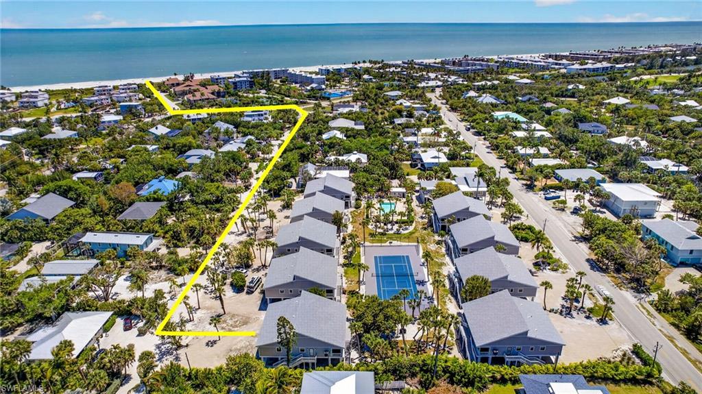Every unit in this complex was raised above the FEMA Flood Elevation, creating parking and storage for each owner under building. New landscaping is planned for the summer of 2026.This Donax Village condo is located on peaceful Cardium Street and is a short 7-10 minute stroll to the beautiful Gulf beaches. This is the best of both worlds - condo living but feels like a residential home. This location is both quiet and close to the causeway. Unit has new electrical, plumbing, new efficiency Standard HVAC system, all windows and doors hurricane impact and low-energy rating, and new Trex decking and staircases. This beautiful 2 bedroom, 2 bath plus loft offers a large screen enclosed tiled lanai. Vaulted ceiling in living room, porcelain tile floors, kitchen with tray ceiling, new stainless steel Frigidaire appliances, shaker kitchen cabinets, quartz counters and vanities, recessed lighting and new fans throughout. New Mohawk carpet on stair treads and loft. Outlets for wall mounted TV's in all rooms and marble sills throughout. The laundry room has full size new Whirlpool washer & dryer and a laundry tub. Enjoy the outdoor shower after a day at the beach shelling. No expense was spared in the remodel of this Sanibel Island get-a-way. A wonderful beach community offering tennis/pickleball and sparkling community pool. Enjoy spectacular sunsets and some of the world's best shelling.