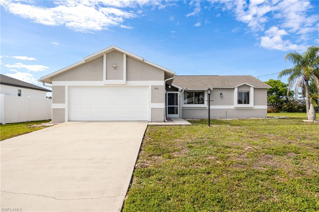Welcome to this beautifully maintained 3-bedroom, 2-bathroom home situated in a desirable NW Cape Coral neighborhood. Freshly painted inside and out, this move-in-ready residence offers a bright and inviting open-concept great room floor plan enhanced by soaring cathedral ceilings, elegant crown molding, and a combination of tile flooring throughout the main living areas and laminate flooring in the bedrooms.  The well-appointed kitchen is designed to impress, featuring attractive granite countertops, rich wood cabinetry, and brand-new stainless-steel appliances—perfect for both everyday living and entertaining.  The spacious primary suite offers a walk-in closet and a renovated private en-suite bathroom complete with a convenient step-in shower. Two additional guest bedrooms provide comfortable accommodations and share a well-maintained guest bathroom with a tub/shower combination. An in-residence laundry area adds everyday convenience.  Step outside and enjoy the Florida lifestyle year-round from the expansive screened lanai with tiled flooring, overlooking the peaceful backyard setting. The attached 2-car garage provides secure parking and features ceiling-mounted storage racks, offering excellent additional storage space.  Additional highlights include an irrigation system to keep the lawn lush and green, and the added peace of mind of being located outside of a flood zone.  Conveniently located near shopping, dining, schools, parks, and all the amenities Cape Coral has to offer, this exceptional home would make a perfect family home or rental property. Schedule your private showing today!