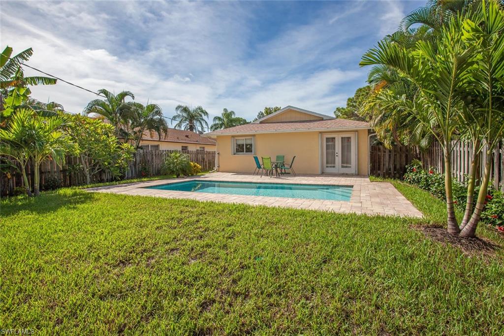 Coastal 3 bedroom, 2 bath pool home in a fabulous location in Naples Park. Huge open floor plan with gorgeous 18” tile flooring throughout, crown molding and recessed lighting. The open-concept kitchen has granite counters, newer cabinets, stainless steel appliances and an island for enjoying morning coffee. The home features stylish newer furnishings, electronics and accessories. Hurricane shutters on all windows provide peace of mind while away, and a sprinkler system maintains the beautifully landscaped yard. An expansive tiled patio overlooks the backyard with a HEATED POOL surrounded by lush tropical landscaping. Enjoy an uptown address with a walkable cosmopolitan lifestyle!