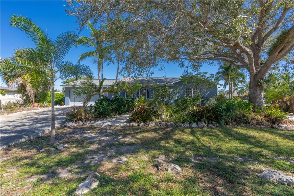This home has VALUE! The roof is new as of 2023, the A/C is new as of 2020, the washer & dryer is new as of 2022, and the refrigerator is new as of 2020.  It sits on a HUGE corner lot with incredibly well-maintained landscaping and is on city water and sewer as well as NOT in a flood zone - HUUUUUGE savings.  The home has tile throughout, granite countertops in the kitchen, an oversized laundry/utility room with plenty of room for storage or built-in shelving, matching blinds throughout, and a brick accent wall in the living area.  The back yard features an oversized lanai (1200sqft) with upgraded landscaping.  San Carlos Park is the single most well-placed neighborhoods in all of Lee County featuring quick access to US-41, I-75, and all major areas of town.