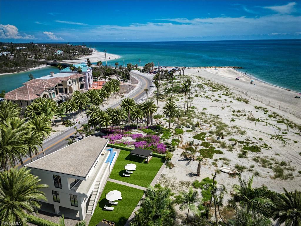 Own this little adorable Captiva beach cottage OR "IMAGINE" and build something incrediably special like the coastal modern masterpiece shown. Displayed are Conceptual renderings of what you could build on this property.  You get to decide! Enjoy this adorable beach cottage or build a new coastal modern "Landmark" getaway. Whats offered at this price is this charming seaside retreat showcases a open layout w/expansive glass sliders that open onto a large deck, offering breathtaking views of the Gulf of Mexico. Nestled just steps away from the Blind Pass bridge, where Sanibel/Captiva converge, Coquina Cottage proudly stands as the first residence on Captiva beach, establishing itself as a landmark destination. With its panoramic beach views, this idyllic getaway boasts a compact yet well-equipped kitchen, two cozy sleeping areas, & a soothing spa. Set on a half-acre waterfront property w/a single dwelling along the Gulf, the cottage is enveloped by tropical native vegetation. Enjoy exceptional fishing, observe marine life & wildlife, indulge in world-class shelling, & enjoy enchanting sunsets on the white sand beach of Captiva.