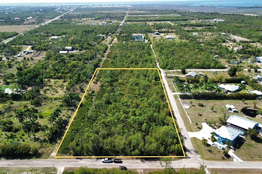 Just off the beaten path in the charming town of St. James City, this plot of land is a sanctuary of privacy and natural beauty, offering over five acres of idyllic landscape with views of neighboring tree farms and island wildlife. Perfect for horse lovers, the expansive grounds provide ample space to accommodate your equestrian dreams, chickens for fresh eggs or just have a beautiful natural landscape. Despite its serene seclusion, this property is conveniently located just minutes from a variety of delightful restaurants and only a short drive to marinas, boat ramps, and some of the best fishing spots in Southwest Florida, ensuring that both adventure and relaxation are always within reach. Whether you're yearning for peaceful solitude or active outdoor pursuits, this unique property embodies the perfect blend of rustic charm and modern convenience, all just a stone's throw from the main road. It is ready to be cleared for your new home palette or a beginner tree farm. When opportunity knocks.... answer the door!!!