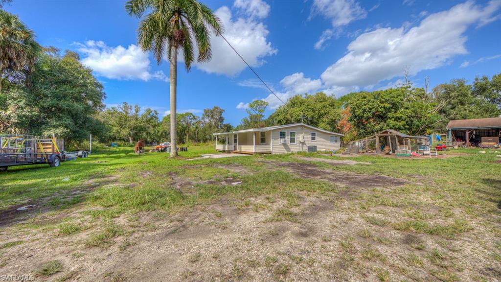 This beautifully secluded single family gem is located in rural North Fort Myers. Property boasts farm style living with the convenience of a coastal lifestyle. Offers fully stocked pond with a dock, large detached 2 car garage/workshop and with the entire 2.16 acres fully fenced you can live out all your agriculture aspirations. This is a lovely 3 bed 2 bath home, offers a great scenery setting with the pond and the bamboo trees making sweet music while you relax. Theres plenty of raw land to continue to develop and enhance, lots of potential in a growing area of SWFL. It's conveniently located among a competitive school system and local family friendly attractions. Interior has upgraded tile flooring and living area windows have sliding shutters, open floor with split bedrooms this home will be move in ready. Being 30 minutes away from local beaches and attractions this home will go fast, so hurry up and grab your very own slice of paradise!