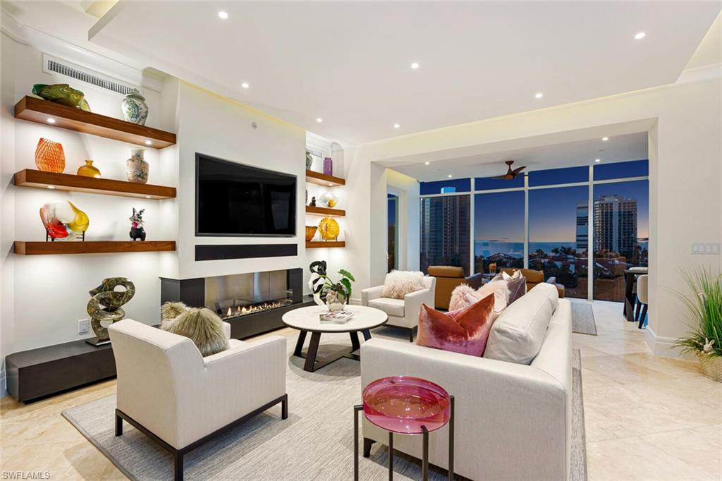 C3940-Welcome to Aqua Vista at The Aria, a sweeping, 8th floor corner unit offering 270 degree views of the Bay, Gulf, & manicured, tropical greenery by day and twinkling lights off the water at night. Remastered unit completely redone with the help of world-renowned Antoine Testard Designs & offers increased sq. footage including a gulf view sunroom and sunny one of a kind office space: NOT your typical 05 floorplan! This bespoke home in the sky is designed for both beauty & efficiency, following the curves of the Aria building giving incredible vistas, everywhere you look! Top of the line finishes throughout every single room plus NATURAL GAS in the kitchen: a true rarity on the Blvd! No detail overlooked, no expense spared. Custom ceiling & lighting design throughout, designer walnut cabinetry, elegant, clean-line built ins, lit shelving, & 2 fireplaces as well! Primary Suite? Generous with gorgeous views & spa-like bathroom: lots of closet space! Guest bedrooms both ensuite and simply gorgeous for your guests. The Aria is a more intimate high rise building yet with every amenity imaginable all impeccably maintained & managed. Walk to EVERYTHING that makes Park Shore the dream!