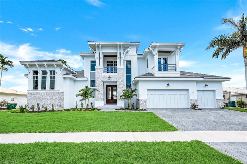 Stunning, brand-new, custom-built coastal contemporary home by Aqua Custom Homes. Quick water-direct access to the Marco River and Gulf of Mexico. Beautiful canal and wide water views from your expansive open lanai with summer kitchen, gas fireplace, sparkling pool and spa. Light and bright open great room concept with soaring 13-foot ceilings, separate dining area, breakfast bar and gourmet kitchen that includes an island with electric cooktop, wall oven and microwave, refrigerator/freezer, butler's walk-in pantry, custom cabinets and quartz countertops. Master suite retreat comes with spacious walk-in closets, soaking tub, dual vanities and large walk-in shower. Three additional en-suite bedrooms offer privacy for your guests. Den/study and additional ½ pool bath on the first floor and open loft space on the 2nd floor with private deck to enjoy the lovely water views. Many custom upgrades throughout, including beautiful hardwood and tile floors, custom staircase, crown molding, tray ceilings, 2 wet bars, 2 wine coolers, stand-alone ice maker, 3-car garage, impact glass windows and doors, roll-down electric shutters and bug screens. New seawall installed June 2021. This spectacular residence comes furnished and is the perfect opportunity to start living in paradise today and enjoy all that Marco Island has to offer!
