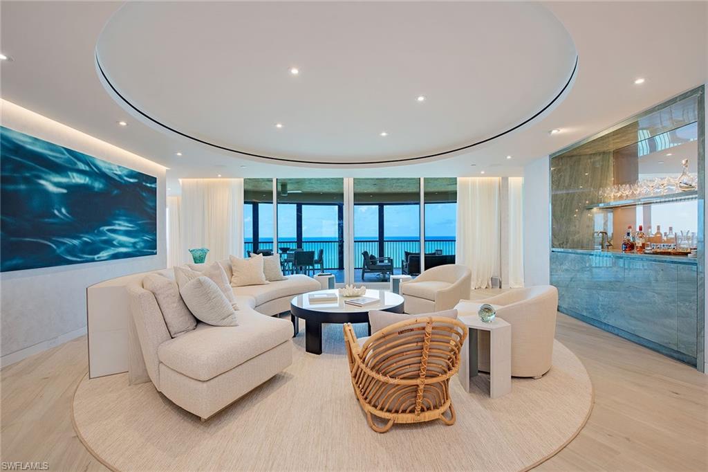 Exquisite, fully furnished three-bedroom plus den/family room, 3.5-bath beachfront residence offering nearly 3,400 square feet of masterfully remodeled space. Every detail has been curated to perfection from designer en-suite baths with custom-lit niches and recessed porcelain baseboards to a stunning emerald quartzite bar and caned kitchen cabinetry topped with natural stone. Custom LED lighting flows throughout, including hidden drapery lighting and under-tub glow. Elevated ceilings with integrated HVAC, floor-to-ceiling solid doors, impact windows/doors, and a smart home system ensure seamless luxury and comfort. Faux-finished living spaces, custom wall coverings in bedrooms, bespoke furnishings, and fully built-out closets elevate the experience. Automated blinds, storm shutters and custom millwork complete this architectural gem. Building amenities have also been stunningly renovated and include a beachfront pool/spa, fitness center, elegant social and board rooms, and direct beach access. Bay Colony Beach & Tennis clubs included. Not included, but available, is opportunity for an immediate golf membership to the Estates at Bay Colony Golf Club.