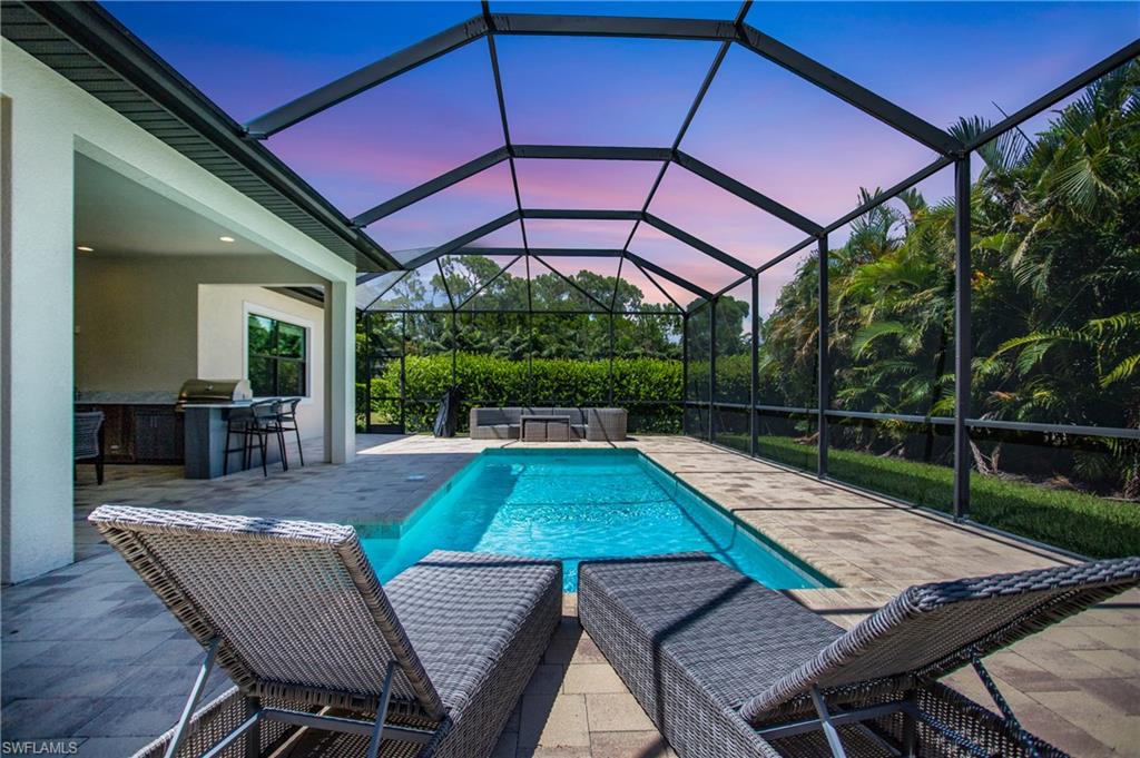 This superb modern home is located in a gated private enclave of only 16 homes, offering privacy and security. It is conveniently located just 4 miles from the beach, 5 miles from shopping and dining, and 6 miles from downtown Naples. Built in 2017, this home features 3 bedrooms plus a den, providing ample space for comfortable living. With 3 full baths, an additional powder room, and a convenient pool bath, all your needs will be met. One of the rare highlights of this property is its 3-car garage, offering both storage space and convenience. The kitchen is equipped with sleek and modern stainless-steel appliances, complementing the custom design and quartz countertops. Elegant tile flooring throughout seamlessly ties the spaces together, adding a touch of luxury. For those who love to entertain, the outdoor kitchen is a true delight. The pool adds another level of luxury and relaxation. The attention to detail in this home is evident, with double crown molding and tray ceilings adding an extra layer of sophistication. Lastly, the impact glass throughout the home ensures both safety and peace of mind. This home offers a complete package of comfort, luxury, and practicality.