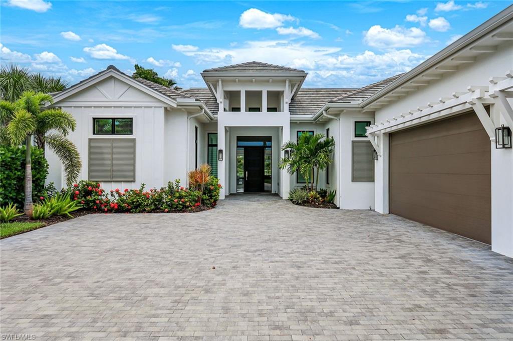 IMMEDIATE FULL GOLF MEMBERSHIP! Designer curated 4 bedroom, 4½ bath home within the exclusive enclave of The Peninsula in Treviso Bay.  Easily entertain in the living area with custom beverage bar and retractable sliders which seamlessly blend the inside and outdoor spaces.  “Everyone gathers in the kitchen” around the enormous center island which seats 6! Culinary creations are easy with the Wolf gas cooktop, wall ovens and large walk-in pantry. The primary suite rivals a boutique hotel with a poolside sitting room/office plus custom walk-in closets. The bath is spa-like and boasts dual vanities, a walk-around shower, dual shower heads and custom niches. Guests have their choice of bedroom suites, each with oversized closets and designer baths. The lanai is expansive with outdoor kitchen. The pool and spa are sun-drenched with water-to-golf views. Oversized 3 car garage, custom wood details, large beverage bar, electric storm screens plus designer wallpaper and lighting. This special home is walking distance to the Treviso Bay golf clubhouse. Full golf membership is immediate and without the heavy buy-in that other memberships require. In addition, members have exclusive access to TPC golf courses worldwide. Multiple dining options plus an extensive calendar of gatherings complete your Treviso Bay lifestyle. Beyond the privacy of Treviso Bay is the renowned dining and shopping of Naples and Marco Island. This home is very special offering and sold beautifully furnished.