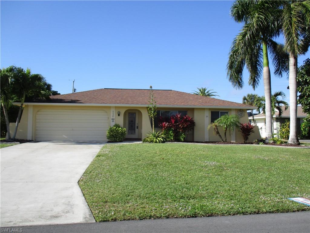 What a neighborhood, what a sunset and no flood insurance needed!!!  This 3/2/2 western exposure move-in in ready home has an over sized fenced in back yard with fruit trees, avocado tree, coconut palms and a sprinkler system!! It also features beautiful mature landscaping including Royal Palms, new carpet in 2016, a new roof in 2012, re-piped and new water heater in 2012, new light fixtures/ fans in 2016 and new duct work in 2016.  You will enjoy sunsets from your large screened in lanai with plenty of room for a pool.  This one won't last long so call today for you private viewing.