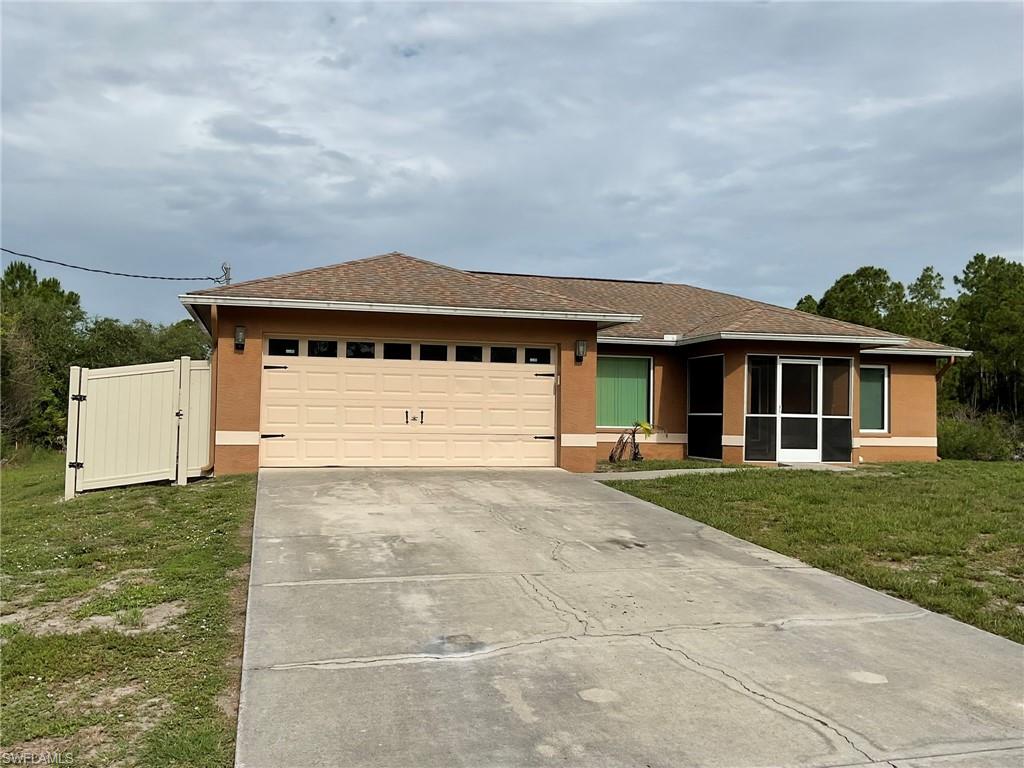 Beautifully maintained 3-bedroom, 2-bath home with a 2-car garage situated on a spacious full 1/2 ACRE piece of land. This inviting home features a desirable split floor plan with vaulted ceilings and an open-concept layout that creates a warm, cozy, and peaceful atmosphere throughout. The kitchen offers an island and breakfast bar while overlooking the main living areas, making it ideal for gathering with family and friends. Tile flooring runs throughout the home for easy maintenance and timeless appeal. Numerous updates provide peace of mind, including a new roof and water system in 2018, impact windows on the front of the home and a new impact-rated front door in 2019, plus hurricane shutters for the rear of the home. Additional improvements include a new water heater, gutters, interior and exterior paint, commercial-grade fencing, screened front entrance, refrigerator, outdoor lighting, and more. Enjoy privacy, space, and comfort both inside and out in this move-in-ready property.