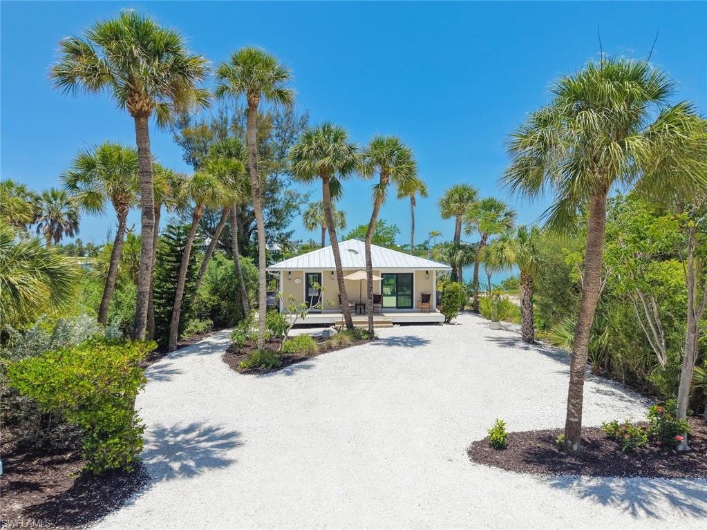 There’s a place where mornings begin with the gentle sound of waves rolling onto the shore, where the first footprints in the sand often lead to treasures washed in overnight by the Gulf. Just steps from one of the world's most renowned shelling beaches, this charming beach cottage invites you to embrace the timeless rhythm of Sanibel Island.

Nestled in the coveted Del Sega neighborhood on Sanibel's peaceful west end, life here moves at a slower pace. Island time isn't just a saying—it's a way of life. Spend your mornings collecting extraordinary shells, watch dolphins and manatees glide through the surrounding waters, and enjoy daily encounters with the abundant wildlife that makes this island so special.

For boating enthusiasts, the location is second to none. With superior boating access, you'll be cruising the Gulf of Mexico within minutes, ready for an afternoon of fishing, exploring secluded islands, or simply anchoring off a quiet beach to soak in the sun. Prefer to stay on land? Hop in your golf cart and take the short scenic ride to Captiva, where waterfront restaurants, charming boutiques, and island entertainment await.
As the day winds down, the home's coveted westerly exposure becomes the star of the show. Unobstructed views across Sunset Bay provide a front-row seat to spectacular sunsets that paint the sky in brilliant shades of gold, orange, pink, and violet—an evening ritual you'll never tire of.
Inside, the home has been thoughtfully updated while preserving its relaxed coastal charm. Beautiful wood flooring, updated vanities, a newer roof, newer air conditioning system, and durable Hardie siding offer peace of mind and modern comfort, allowing you to spend less time maintaining and more time enjoying everything island living has to offer.
Whether you're searching for a full-time residence, a vacation retreat, or an investment in one of Florida's most treasured island communities, this exceptional cottage offers something increasingly rare: a lifestyle where every day feels like a getaway, every sunset feels unforgettable, and the simple pleasures of beach, boating, and nature become part of your everyday story.
