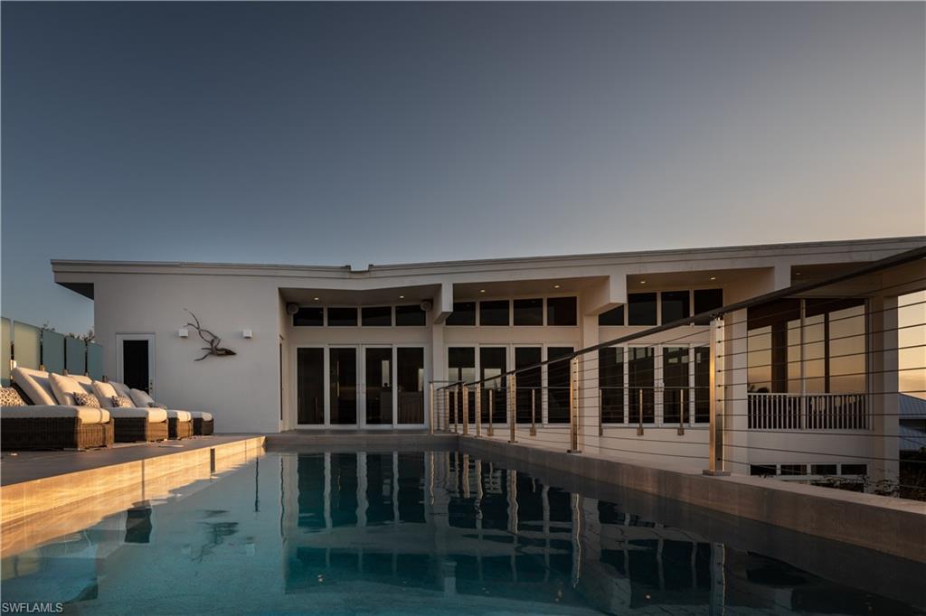 Private Island Luxury. A yachtsman's dream with direct access. This exclusive rare offering is in the highly coveted, exclusive and historical enclave of Key Marco. Sweeping 180 degree panoramic views of Marco Island, Barfield Bay, Caxambas Pass and the Gulf of Mexico. This 4100 SF 4 BR/5BA home was designed by John Thorne- Architect as a modern contemporary with attention to views and natural surroundings. Four levels with elevator. The mid level owners suite features, office, lux bath and large professionally finished WI closet. Lower level features two guest ensuites each with it’s own bath, a private kitchen and private lanai. The top level living area was designed for entertaining with large open concept living space flowing to the rooftop pool and lanai. Home Electronics, Gas Viking Cooking and Home Generator. Lutron, LED, Ultimate three car garage and more. Indescribable- unless you see it!