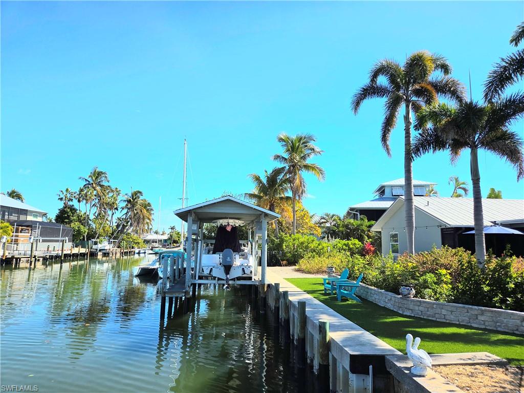 Great location in that it's the 2nd canal in from the bay taking just a couple of minutes to San Carlos Bay, and ten minutes more to Sanibel Island by boat. Great location in St. James City on Pine Island in the beautiful Bayview neighborhood. This 3 bedroom, 2 bath home was completely remodeled after Hurricane Ian. 1,550 square feet PLUS an approximately 400 square foot sun room (with portable AC included) on the canal side and another 400 square foot travertine patio that leads to the boat lift. The interior is completely tiled, even the sun room. You will love the low maintenance yard that has beautiful gardens and palm trees. The home boasts a new HVAC with a raised outside unit, plus a 3 zone irrigation system with timer. The kitchen has stainless steel appliances that will remain. All windows and doors are impact resistant. No flooding inside during last 2 storms.  This s is a great waterway neighborhood with easy to reach beaches and restaurants by boat. There are great and fun restaurants nearby that are golf cart or bicycle distances away when you are not boating to Sanibel, Captiva, Cayo Costa or Cabbage Key. This is such a great location for boaters. Oh, and the Manatees love this canal. You can sit down by the canal on the beautiful area with easy care artificial turf watching all the wildlife. The boat lift has a new, all aluminum cradle with new cables as well. You're going to love this house. Make an appointment to see it today.