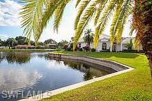 On a beautiful palm tree lined street in this coveted gated community, this home is a true find and has much to offer the keen buyer.  9731 Mainsail Ct. located on a corner lot offers wide water views and southern exposure from the pool and lanai area. This 3 bedroom, 2 bath, has a floorplan which flows easily from living area to kitchen and dining area with true hardwood floors and tiling throughout.  Elegant and sturdy, this property has stellar features such as electric storm shutters in key areas as well as manual shutters, solar heating for the in ground pool and a central vacuum system.  Caloosa Yacht and Racquet Club community has LOW HOA fees.  Amenities include - Membership in the Blue Coyote Private Dinner club which has marina and river views, community pool, tennis and pickle ball, a 22 acre lake and 4 acre park for jogging, walking, biking, barbecuing and even an organic gardening plot.  The private marina offers boat slips for the low fee of $3.50 per/ft. and has a no bridge access to Gulf from the Caloosahatchee River.  Superb location close to grocery stores, soon to open Whole Feeds, restaurants, health clubs and the SWFlorida Intl airport.