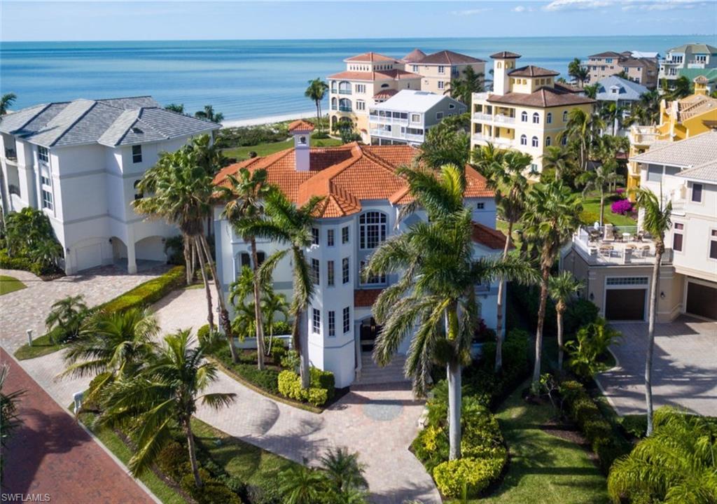 Coastal contemporary Barefoot Beach home with spectacular Gulf views. This all concrete block home enjoys a rare double homesite with palatial ambiance, in one of the most spacious Beach Gardens in Barefoot. Recently extensively-renovated, this estate boasts marble floors, soaring ceilings, designer lighting fixtures & new paint inside & out in a cool, neutral color palette—reminiscent of contemporary new construction. Also includes hurricane impact glass, automated shutters, 4-zone A/C, security system, central vac, lightning rods, elevator, 3-car garage, uniquely ample parking & balconies with glass panels to enjoy the unobstructed Gulf views. Open floor plan with private guest level with 2nd living space & its own full entertainment kitchen with refrigerator, dishwasher, microwave & wet bar. Unparalleled chef’s kitchen with 2 oversized islands, marble backsplash, custom cabinetry, walk-in pantry, Viking gas range, SubZero fridge, Bosch wall oven, microwave, dishwasher & more. Steps to pool & Club at Barefoot (room for private pool). Perfectly-located in Collier County’s premier waterfront gated community of Barefoot Beach, minutes to Mercato, Waterside Shops, Promenade & more.