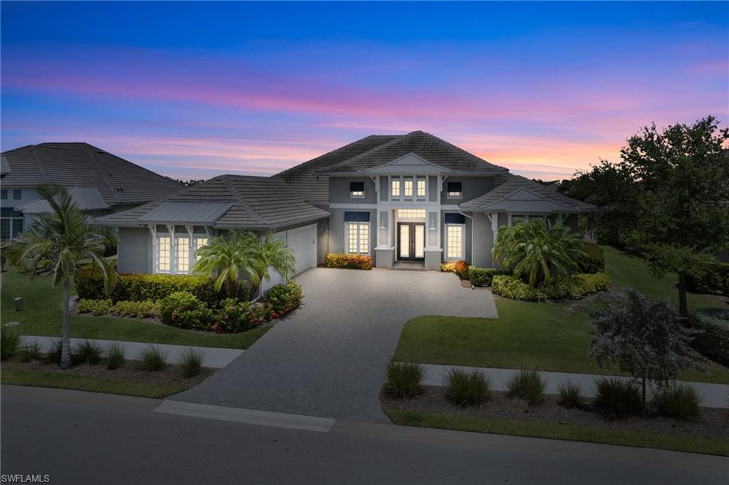 Welcome to the most EXEPTIONAL VALUE, amongst Stock Development's large homes, currently available in the prestigious Isles of Collier Preserve. This property is a masterpiece of refined coastal elegance where timeless design meets modern luxury. This meticulously crafted 4 bedroom + den, 5 bath residence offers the perfect blend of comfort, sophistication, and serene lakefront living.

Situated with broad lake views, this home showcases a spacious split-floor plan, ideal for privacy and entertaining. From the moment you enter the home, you’re greeted with soaring 14' tray ceilings, and an abundance of natural light that pours through oversized windows and sliding glass doors, framing the tranquil water vistas.

The chef’s kitchen is a dream come true—complete with top-of-the-line stainless steel appliances, custom cabinetry, an oversized island with ample seating, quartz countertops, and a large pantry. The open concept living room flows seamlessly into the expansive outdoor living space, creating the perfect backdrop for hosting guests or simply relaxing in luxury.

Retreat to the sumptuous primary suite, featuring peaceful lake views, a spa-inspired bathroom with dual vanities, an oversized walk-in shower, soaking tub, and dual walk-in closets. Each of the three guest bedrooms offers en-suite baths and generous walk-in closets, providing comfort and privacy for family and visitors alike. 

Step outside to your own private oasis: a resort-style pool and spa, expansive travertine paved lanai, and summer kitchen—all overlooking breathtaking lake views. Whether you’re enjoying a quiet evening or entertaining under the stars, this outdoor sanctuary is nothing short of spectacular.

Residents of The Isles of Collier Preserve enjoy access to a host of world-class amenities, including a state-of-the-art fitness center, resort and lap pools, tennis and pickleball courts, kayak and paddleboard launch, 8 miles of scenic trails, and the charming Overlook Bar & Grill. All just minutes from downtown Naples, 5th Avenue dining and shopping, and the white-sand Gulf beaches.

This is more than a home—it's a lifestyle of luxury and leisure. Schedule your private showing today and experience coastal living at its finest.