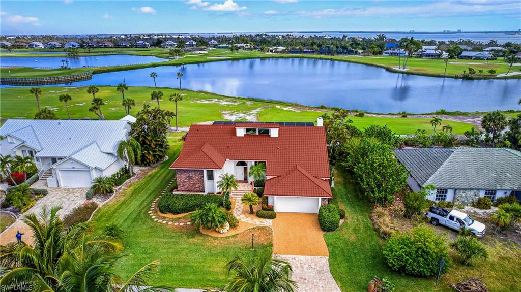 Elevated, impeccably maintained, and built with exceptional craftsmanship—this 3-bedroom, 2-bath home in the highly sought-after Dunes of Sanibel is a rare offering that blends quality construction with effortless island living. Designed for both durability and timeless appeal, this solidly built residence showcases expansive lake and golf course views, creating a serene backdrop that truly defines the Sanibel lifestyle.
Inside, soaring vaulted ceilings and a striking brick gas-burning fireplace with custom built-ins anchor the spacious living area, offering both warmth and architectural character. Natural light pours in, enhancing the open feel and seamless flow throughout the home. The well-appointed kitchen is designed to impress, featuring stainless steel appliances, a double oven, gas cooktop, granite countertops, and premium Poggenpohl cabinetry—perfectly suited for both everyday living and entertaining.
Step outside to the expansive rear deck, where you’ll enjoy sweeping views of the golf course and pool below—an ideal setting for hosting gatherings, relaxing with a morning coffee, or taking in Sanibel’s breathtaking sunsets. The new metal roof, designed to mimic the look of tile, adds both style and long-term peace of mind.
A spacious garage provides excellent storage, but what truly sets this home apart is the massive concrete lower level beneath the entire structure—an incredibly rare, “bunker-like” space offering endless possibilities for storage, workshop use, or added security. It’s a standout feature that speaks to the home’s superior construction, something you simply don’t find in newer builds.
Located within the Dunes community, residents enjoy access to golf, tennis, and a vibrant island atmosphere. Even better, this property includes deeded beach access, allowing you to easily enjoy Sanibel’s world-renowned shelling beaches just moments away. Bike paths, dining, and shopping are all within easy reach—this is truly Selling Sunshine on Sanibel, where every day feels like a vacation. 
This is more than just a home, it’s a lifestyle defined by quality, views, and the very best of island living.