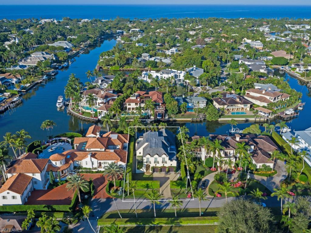 Situated along Marina Drive, an exhilarating setting along Aqualane Shores' most majestic streets, this meticulous residence offers a sophisticated spin to French-inspired architectural design with stunning western-facing waterfront vistas towards Kite Cove and Jamaica Channel. Designed by the renowned Herscoe Hajjar Architects, LLC & constructed in 2006, great attention has been given to elegant & spacious living design, natural lighting, quality finishes & expansive outdoor entertaining areas. This property offers 4 bedrooms plus library, 4 full baths, 2 half baths & private in-residence elevator. Thoughtfully enhanced circa 2011 and 2018, luxury appointments include Bordeaux limestone, marble and Brazilian cherry wood flooring throughout, gas fireplace with marble mantle, wine room, custom wood beams ceiling treatments in the great room, chef-inspired kitchen, screened outdoor terrace with cypress-paneled ceiling & summer kitchen, 3-car garage, ample storage and generator-ready construction.To truly appreciate the timelessness and beauty of this home, one must view it in person.