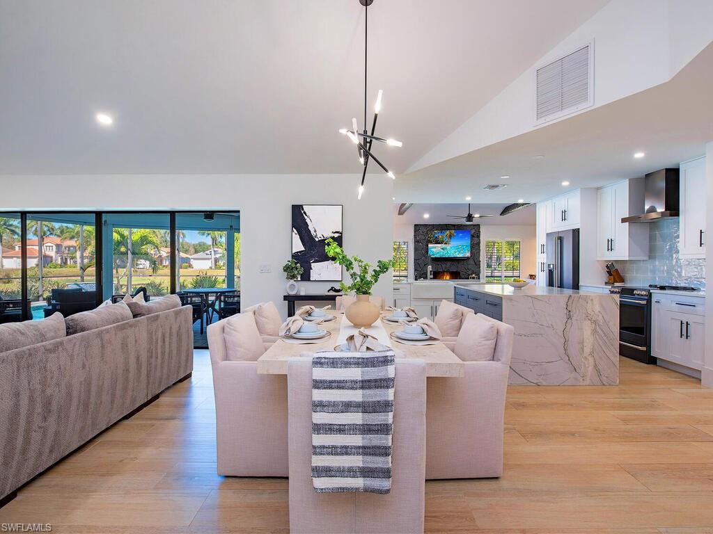 Designed as a forever home, this fully renovated modern farmhouse in Spanish Wells blends impeccable craftsmanship, elevated finishes, and inviting indoor–outdoor living. From the book matched waterfall quartzite island and custom walnut bar to the spa-like primary wet room and serene lake and golf course views, every detail was intentionally curated for both beauty and function. This single-story 3-bedroom, 3-bath home in Spanish Wells Golf & Country Club offers 2,372 sq ft under air and was completely reimagined with openness, flow, and high-end finishes throughout. There are expansive entertaining spaces, featuring cathedral ceilings in the great room, vaulted beams in the secondary living area, and layered LED lighting—all on dimmers for a warm, refined ambiance. The chef’s kitchen and custom bar anchor the home, showcasing semi-custom cabinetry with soft-close doors and under cabinet lighting, rollouts, hidden trash, and a panel-ready dishwasher. Quartz and honed quartzite countertops elevate the space, while the oversized island provides ample prep space and area to gather. Appliances include a GE Café range and refrigerator, Bosch dishwasher, Wolf microwave drawer, and a standout custom walnut bar with floating LED-lit shelves, a Thermador 58-bottle wine fridge, concealed refrigerator drawers, and wood burning fireplace to compliment the mood. All bathrooms feature walk-in showers with porcelain tile and custom niches. The primary suite is a true spa retreat with a custom wet room, dual shower heads, freestanding soaking tub, large-format 4’x4’ tile, handheld, and backlit mirrors. 12" porcelain wood-plank tile runs throughout the home, complemented by 8” baseboards, single panel shaker doors, and thoughtful design details at every turn. Outdoor living shines with a covered lanai, full outdoor bar with sink and refrigerator drawers, new pavers and tile (2024), custom water feature, and brand-new pool heater (2026). Enjoy tranquil lake and golf course views of the 5th hole on the North Course, surrounded by upgraded landscaping. Built-in hurricane shutters—including electric sliders and windows—make storm prep effortless. Additional highlights include whole-home Sonos surround sound, smart thermostat, full plumbing re-pipe to PEX (2019), new AC (2024) relocated to the garage, and an oversized two-car garage with epoxy floors and newly installed hurricane impact garage door (2026). HOA dues under $250/month include cable, internet, sewer, and trash. Centrally located just minutes from beaches, dining, shopping, downtown Bonita Springs, and RSW Airport, this home offers a rare blend of design-forward style and everyday functionality—perfect for entertaining and refined Florida living. Skip the dust, decisions, and disruption. Every detail of this completely 
reimagined residence has been carefully renovated so you don’t have to. Just turn the key and step into your beautifully finished home designed for modern living.