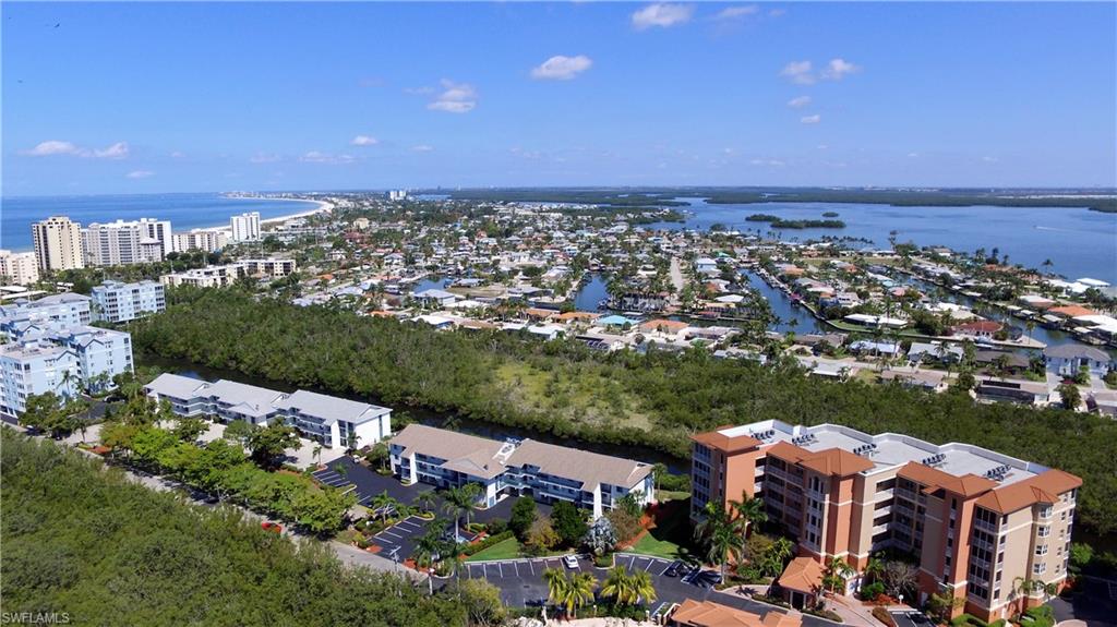 "Where can you find a beach condo under 300K?  Right here. Two bedroom/two bath adorable unit which is not currently used as a rental, although rentals are allowed. Lots of upgrades including newer furniture, counter tops, vanities, fans, recently painted, vinyl sliding doors to the lanai with storm resistant panels, master bath redone 2019, new flooring in 2020,new A/C in 2017 and an in-unit washer and dryer. Kitchen appliances were replaced in the last 5 years.  A top floor unit with ground level carport, storage shed, two bicycles and beach equipment, It's only a short walk to the white sandy beach, shopping, fine restaurants, the Santini mall, and the theater. Situated in quiet surroundings away from road noise, the screened lanai overlooks the tidal canal and wildlife sanctuary where you can watch the ospreys, pelicans and leaping fish. It has a community grill and tiki hut for your friendly get togethers. There are two pools available to the tenants, as well as  tennis, pickle ball  and shuffleboard.