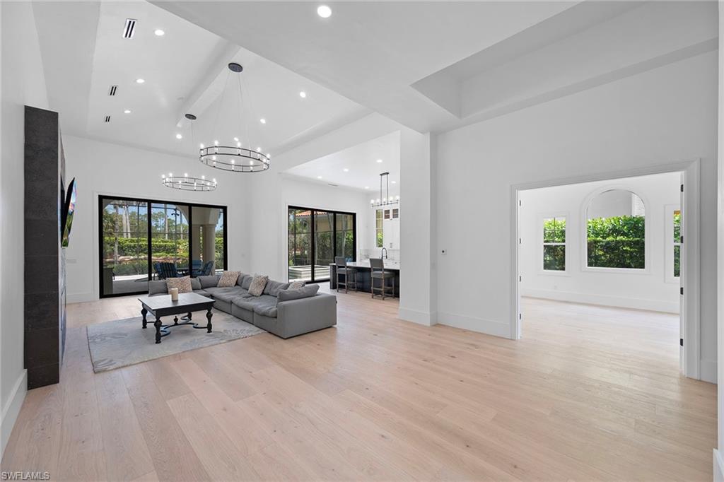 AVAILABLE furnished or unfurnished ANNUALLY or for 6+ MONTHS.  Located in the gated, prestigious North Naples community of Norman Estates in Tiburon, you'll be the first to enjoy the stunning changes and upgrades made to this 5 bedroom + den pet-friendly home. All of the living space is located on the first floor with the exception of two guest bedrooms and a full bath on the second level.  Enter the home through the oversized two-car garage or the charming courtyard, and you'll see soaring ceilings making the Great Room look even more grand. The kitchen is truly set up for entertaining with an island bar, tons of storage and sliding glass doors to the screened lanai lending itself to pool side beverage service as well as preparing meals at the outdoor kitchen / grill area. There is ample space in the Great Room to establish a formal or informal dining area or to set up several seating areas for cocktails or cards.  The first floor Primary Bedroom Suite has its own foyer area and two walk-in closets separating the bedroom itself from the gorgeous spa-like bath. Beautiful windows offer views of the gorgeous landscaping by day and the lit swimming pool by night. The heated and screened swimming pool/hot tub enjoy lovely afternoon sun and sunsets. A second bedroom suite with a full bath is located near the front of the house near an additional half-bath. Den access is through double glass doors and affords a view of the charming courtyard shared with the detached Guest House/Cabana with its own kitchenette and full bath. Two second-floor guest bedrooms each have an open balcony and share a full bath. This home is available unfurnished or furnished for 6+ months and your well-behaved pet is welcome.