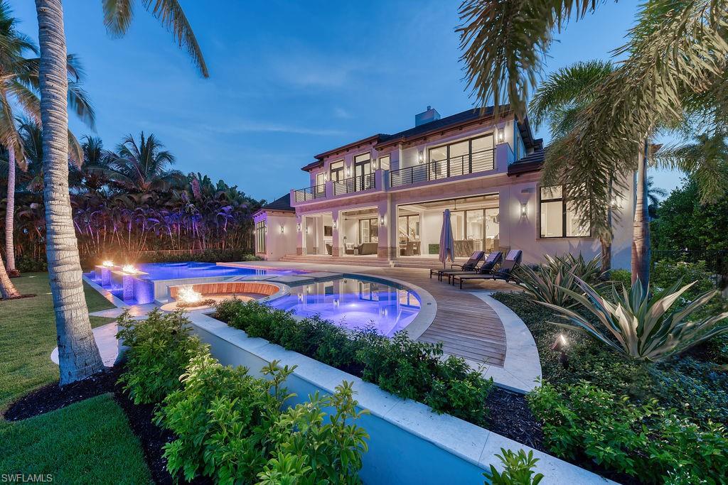 Key enhancements are underway to improve this already remarkable property!!  Just beyond its stately front gates lies one of the most exciting New Construction opportunities on the market today. With 140 feet of water frontage this magnificent home built by A. Vernon Allen Builder can accommodate a large boat and provides no bridge access to the Gulf. Delivering a coastal-inspired aesthetic this home features a show-stopping 80-FOOT POOL AND SPA COMPLEX with a 3-sided infinity spill-over edge, linear fire features, sun shelf, Brazilian hardwood decking and an embedded firepit. Sliding glass doors fully pocket away for a seamless transition from the expansive outdoor area to a spacious interior which includes: 2 sumptuous primary suites (one upstairs and one downstairs), 4 guest suites, whole-home generator, thoughtfully placed wood accents, an elevator, built-in wine nook, Lutron lighting system with Control 4 automation, a steam shower and an extended lanai with an outdoor pool bath. This impressive property exudes quality and is enveloped by lush, tropical landscaping. With a cul-de-sac location providing extra privacy you'll feel as though you’ve entered your own secluded resort; a world unto itself.