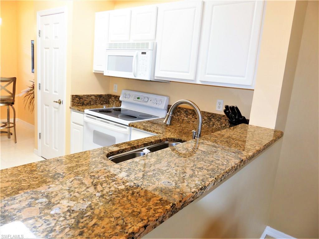Location, Location, Location!! This low priced GOLF MEMBERSHIP home is only steps to the Clubhouse & Tennis courts!! The convenience means you won't even need a vehicle seeing all your amenities are only steps away and include Championship Golf, Boccee Ball, 7 Har Tru Tennis courts, Pickle Ball, Exercise Facility with tons of classes to choose from.. Everything from Yoga & Zumba to Pilates and Water Aerobics, huge lagoon style pool with water fall and spa AND 4 convenient places to dine (one to be completed by the end of the year), which includes formal dining room, snack shack, casual sports pub and a gorgeous outdoor terrace lounge!! This beauty is extremely well kept and has newer carpet, A/C, Dishwasher, Refrigerator, tiled lanai, custom light fixtures, GRANITE counters and an enclosed lanai w/ spectacular views of the aqua range, 1st & 10th hole and clubhouse!! Another huge benefit is.. This building just put on a new roof and it's all paid for in full, so no worries of roof assessments!! Great Views, New Roof, meticulously kept, low taxes, no cart fees, GREAT LOCATION and low priced golf home, move in ready and waiting for you to call it home!!