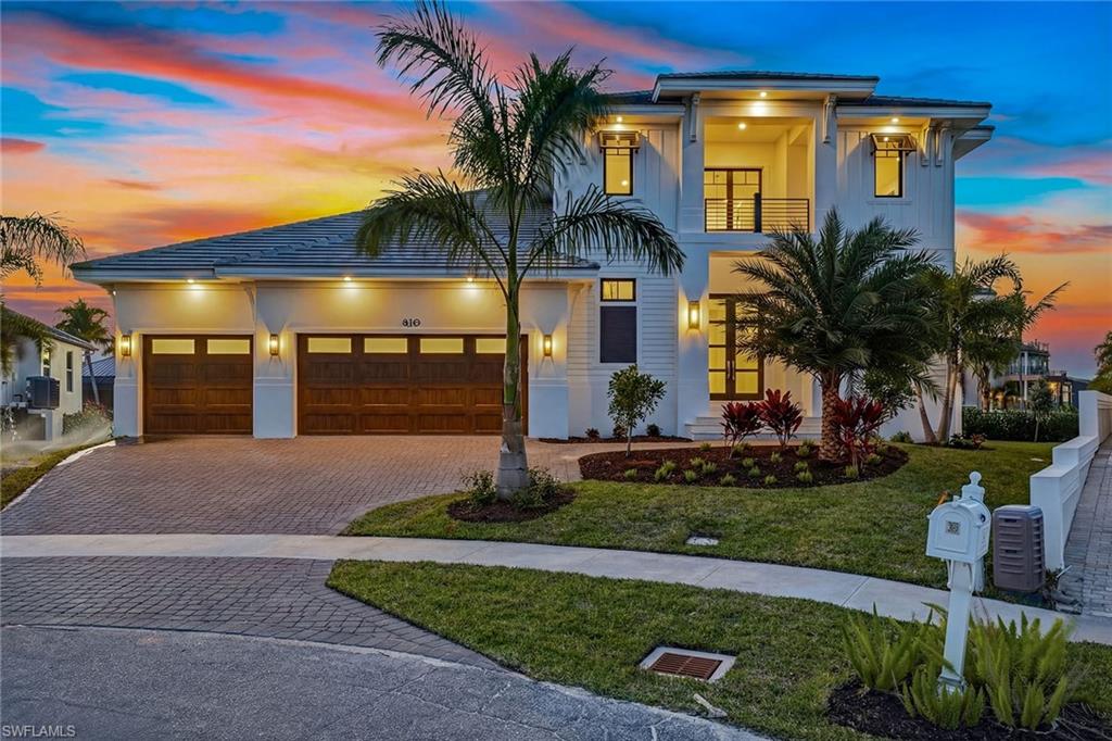 Experience refined living in this exceptional new construction estate, just completed January 2026 by award-winning Stonebreaker Builders, where architectural brilliance and timeless craftsmanship converge. Set on a rare tip lot offering 176 feet of waterfront, this residence captures mesmerizing western sunset views over expansive converging waterways, with vistas stretching across Collier Bay toward the Gulf. This is a rare opportunity to own a custom Stonebreaker home in one of the island’s desirable neighborhoods, offering proximity to Snook Inn, Old Marco entertainment district, the Esplanade and Residents’ Beach. Designed for luxury and livability, the impressive 3,896-square-foot two-story estate offers 176 feet of waterfront and quick direct Gulf access, an exceptional advantage for boating enthusiasts. This five-bedroom residence features five full en-suite baths, two half baths, a flex room and a three-car garage, all executed with Stonebreaker’s signature attention to detail. The exterior showcases a flat tile roof, impact doors and windows, an elevated homesite over 11 feet, a 1,000-gallon propane tank and a 32kW whole-house generator. A grand foyer with a soaring two-story ceiling immediately sets an elegant tone. The open-concept great room, kitchen and dining area feature 12-foot ceilings and expansive glass accordion doors that frame shimmering pool and bay views, creating effortless indoor-outdoor living. The great room centers around a striking 60-inch gas fireplace with a tray ceiling, while the chef’s kitchen impresses with a beamed ceiling, gas cooktop, large center island and walk-in pantry. The outdoor living area is ideal for luxurious waterfront entertaining, offering a covered lanai with an outdoor kitchen, built-in gas grill, outdoor shower, a dedicated pool half bath, and a 30-foot pool with spa and sun shelf. The main-floor owner’s suite offers serene retreat with lanai access, two walk-in closets and a spa-inspired bath with dual vanities, a built-in makeup counter, linen closet, dual walk-in shower with multiple shower heads and a deep soaking tub. A secondary owner’s suite on the first floor also offers lanai access, a walk-in closet and en-suite bath. Upstairs, a spacious flex room creates an ideal lounge space and opens to a remarkable 65-foot covered balcony overlooking Collier Bay and the Gulf. Three additional second-floor bedrooms each feature private en-suite baths. Additional highlights include a mudroom off the garage and a tankless water heater. Just completed, embrace sophisticated waterfront living in this unparalleled Marco Island residence, crafted with exceptional quality.