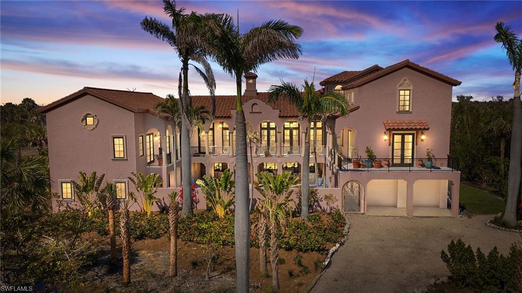 This exceptional custom-built home, meticulously designed and crafted by the sellers, offers the perfect blend of luxury, privacy, and craftsmanship. With 4 bedrooms and 3.5 baths, one of the bedrooms features a private, separate entrance—ideal for guests or extended family. The architectural style, reminiscent of a Mediterranean villa, invites you in with a long, private driveway that leads to a stunning wrought iron gate. An entry gate opens to reveal a magnificent courtyard complete with a charming pool and spa, along with a spacious patio area perfect for al fresco dining. Surrounded by iron gates, the pool area allows for refreshing breezes to flow through, creating an inviting, serene environment. Inside, the home is designed to impress at every turn. The kitchen is a true showstopper, featuring a vaulted ceiling with beautiful wood beams that carry through to the living and dining rooms. The kitchen boasts granite countertops, custom cabinetry, and high-end appliances, including a Thermador 6-burner stove, alongside a convenient butler's pantry. The living and dining areas are bathed in natural light, thanks to the abundance of windows and French doors that open to the picturesque balcony. The primary suite is an oasis of luxury, offering access to a balcony with sweeping views of the pool and tropical landscaping, along with a spa-like bathroom. The second floor is home to two guest rooms that share a spacious Jack and Jill bathroom. A charming den or office, featuring custom built-ins, adds even more functionality to this thoughtfully designed home. For added privacy, the guest suite, accessible via the balcony, includes an ensuite and a loft for little ones—perfect for extended stays or visiting friends and family. Every detail has been thoughtfully curated, from the travertine floors throughout the living areas to the high ceilings with beam work, crown molding, and exquisite gas fireplace in the living room. The home also boasts impact windows, a new tile roof, custom draperies, and hand etched doors that elevate its elegance. Additional features include ample storage, garage and bonus space, all while offering complete privacy overlooking a preserve and an eagle’s nest. Just a short walk or golf cart ride away, you'll find deeded beach access, where you can enjoy the famous Sanibel beaches in mere minutes. Situated in the highly sought-after Gulf Ridge community, known for its exquisite homes, this property is a one-of-a-kind gem. Built with the utmost attention to detail and quality, this home is truly a rare opportunity for those seeking luxury and tranquility.