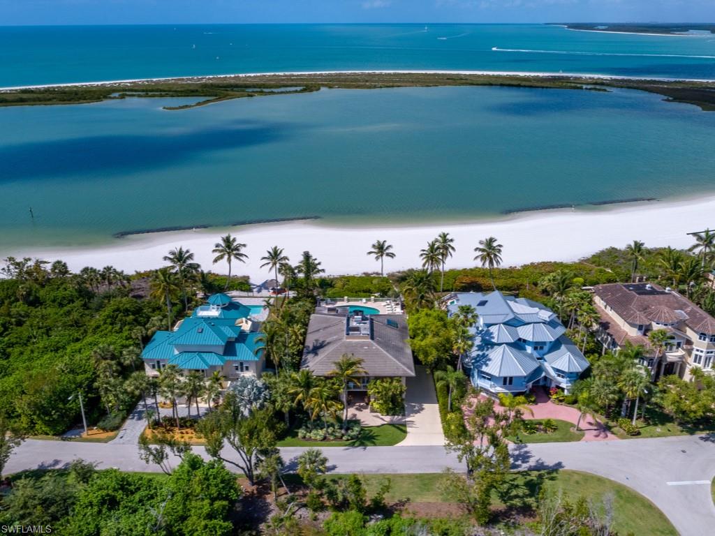 Reminiscent of a "Malibu beach resort", from the moment you step inside you'll agree this airy seaside residence offers some of the best views of the Gulf of Mexico! Professional designer features include custom solid wood wainscoting on walls that took this superb home to another level, the grand living room is light & bright with high ceilings and breathtaking views, there is a state-of-the-art culinary kitchen with Subzero & Wolf appliances, the dining room has a fireplace & is perfectly situated beach side, escape to the master suite and you'll imagine you've entered a luxury spa, plus there is a phenomenal sound system! Intentionally crafted with balconies & patios on all sides for the utmost pleasure from this tropical island lifestyle. Newer massive beach side pool, spa and pool deck to enjoy the sunshine during the day as well as the evening watercolor sky from this NW exposure setting! Right on the sandy beach, 3 doorsteps to the Beach Club, at world-class Hideaway Beach, a gated community with amenities such as golf, tennis, beach side dining, club house dining, bocce, pickle-ball, fitness club, social events, personnel at Club gatehouse entry 24 hours and more!