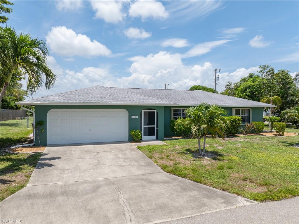 Welcome to a home that has been cherished by its original owner and thoughtfully maintained over the years. Situated on an oversized corner lot in a quiet Southeast Cape Coral neighborhood, this affordable pool home offers the perfect combination of comfort, convenience, and peace of mind—with no flood insurance required.

Inside, you'll find a spacious split-bedroom floor plan designed for privacy and everyday living. The generous primary suite features a large walk-in closet and private bath, while the guest bedrooms are comfortably sized and located on the opposite side of the home. The living spaces flow seamlessly to the expansive lanai, where you'll enjoy both covered seating areas and plenty of room to soak up the Florida sunshine.

Step outside and discover your own tropical retreat. The sparkling pool is perfect for cooling off on warm summer days, and the mature mango tree is currently producing an abundant harvest of delicious fruit. Whether you're entertaining friends or simply relaxing at home, the outdoor space offers endless enjoyment.

Conveniently located near shopping, restaurants, medical facilities, and everyday essentials, this home puts everything you need within easy reach. City water and sewer assessments are in and fully paid. Major updates include a 2017 roof, 2016 water heater, and 2013 A/C.  Sprinkler system has not been used for many years - assuming it is not working.

A well-loved home in a fantastic location, ready for its next chapter. Easy to show and easy to love!