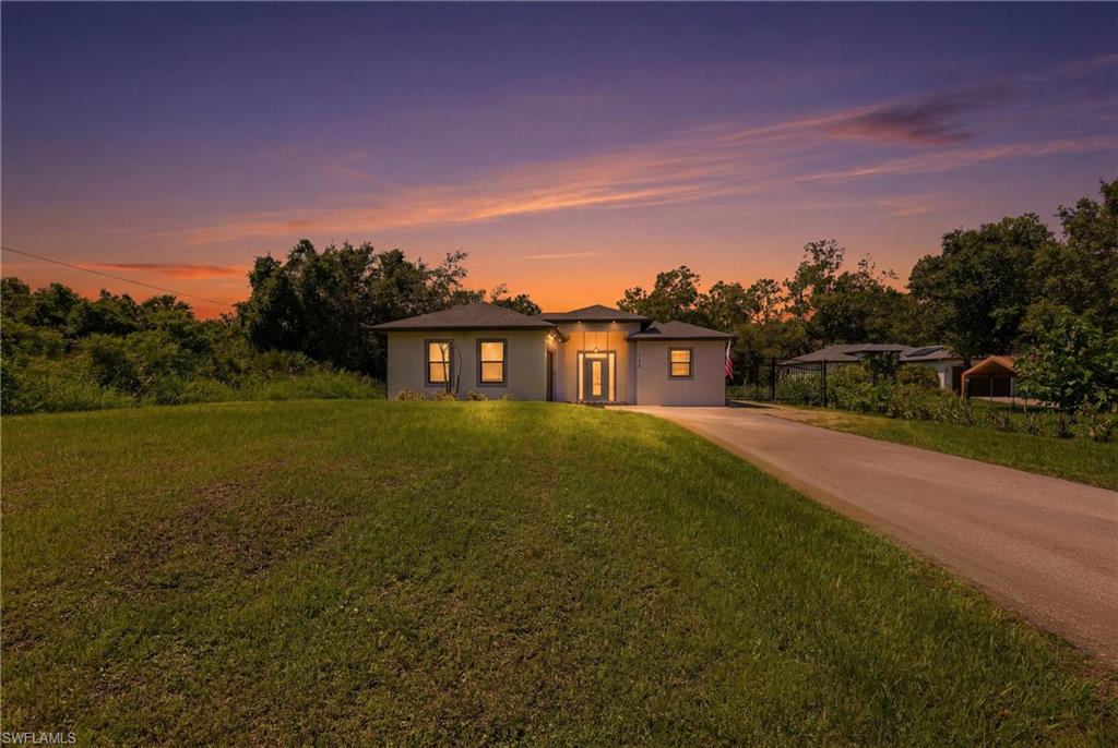 One or more photo(s) has been virtually staged, AI generated or rendered.  Beautifully Home designed single-family home featuring 3 bedrooms plus a den, 2 bathrooms, and a 2-car garage, situated on a private 1.14-acre lot. This spacious open floor plan offers white quartz countertops, custom Italian wood cabinetry, stainless steel appliances, and tile flooring throughout the main living areas. The versatile den provides the perfect space for a home office, playroom, or guest room. Enjoy Florida living at its finest with an amazing outdoor kitchen, ideal for entertaining family and friends year-round. The extended driveway leads directly to the garage and offers ample parking for multiple vehicles. The acres lot provides privacy, peace, and plenty of room to store boats, RVs, trailers, Room for pool and other recreational equipment. Conveniently located near Ave Maria, shopping, dining, and schools, with easy access to Naples' beautiful Gulf beaches. This move-in-ready property offers the perfect combination of modern finishes, functional living space, and acreage to enjoy the Southwest Florida lifestyle.