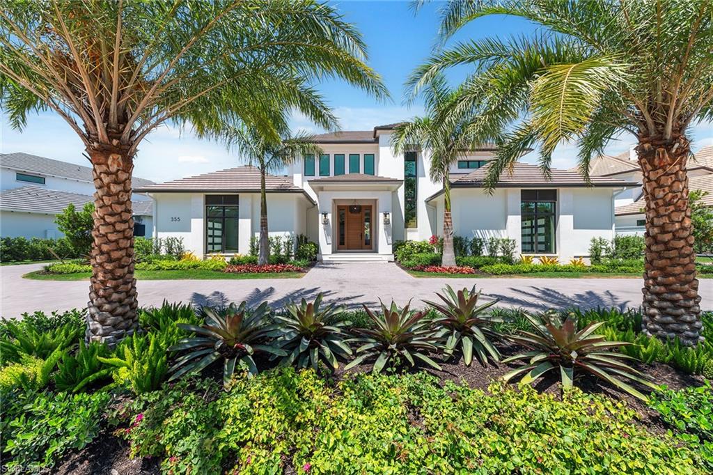 Lakefront Estate home in Bay Colony Shores! Introducing an expertly designed and masterfully constructed estate by Stock Custom Homes situated on one of the most prime west-facing lakefront lots in Bay Colony. Comprising over 6,300 square feet of designer interior living space with five bedrooms, five full baths and two half baths impressively transformed by renowned design firm Marc-Michaels Interior Design. Upgraded features include large format tile and wide plank wood flooring, wine room, designer Sub-Zero refrigeration, Wolf 48-inch sealed six-burner range top, Wolf double wall oven, convection oven, warming drawer, home automation and lighting control. The owner’s bedroom suite offers wood detail in coffer, walk-in shower with Brizo showerhead, rain head, body sprays and freestanding tub. Saltwater pool with spa, sun shelf, fire and water bowls and linear fire pit, an outdoor kitchen with NatureKast cabinets and a built-in grill. Four-car garage with epoxy flooring. Enjoy the ultimate Naples lifestyle in Bay Colony.