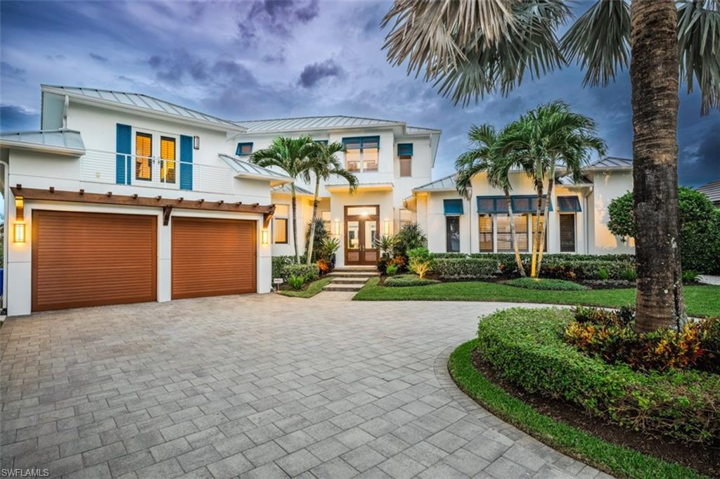 Nestled in a coveted Royal Harbor cul-de-sac with direct access to the Gulf of Mexico, this stunning custom home offers an unparalleled waterfront lifestyle with an impressive 188 feet of pristine water frontage. Spanning approximately 5,537 square feet, the residence showcases open interiors adorned with exceptional artisan finishes and luxurious details that create a warm and inviting atmosphere. Featuring four well-appointed guest suites and a separate study, this home is perfect for both relaxation and entertaining. The gourmet kitchen is a chef’s dream, combining style and functionality with a large center island, professional-grade appliances, a walk-in pantry, and breathtaking water views. It seamlessly flows into the covered lanai, ideal for al fresco dining and gatherings.
The grand great room is a showstopper, with floor-to-ceiling doors that open to spectacular outdoor spaces, including a sparkling pool, lush grassy area, and a boat dock equipped with a newer 16,000 lb boat lift. Additional highlights include an approximately two-year-old seawall, a whole house generator, Car Lift (giving it a 4 Car Option) and meticulous attention to detail throughout. This architectural masterpiece is truly a gem within an exclusive boating community, offering both luxury and convenience. Located just minutes from the vibrant dining and shopping of downtown 5th Avenue South and Third Street South, as well as the stunning white sand beaches, this home is the epitome of coastal living at its finest.