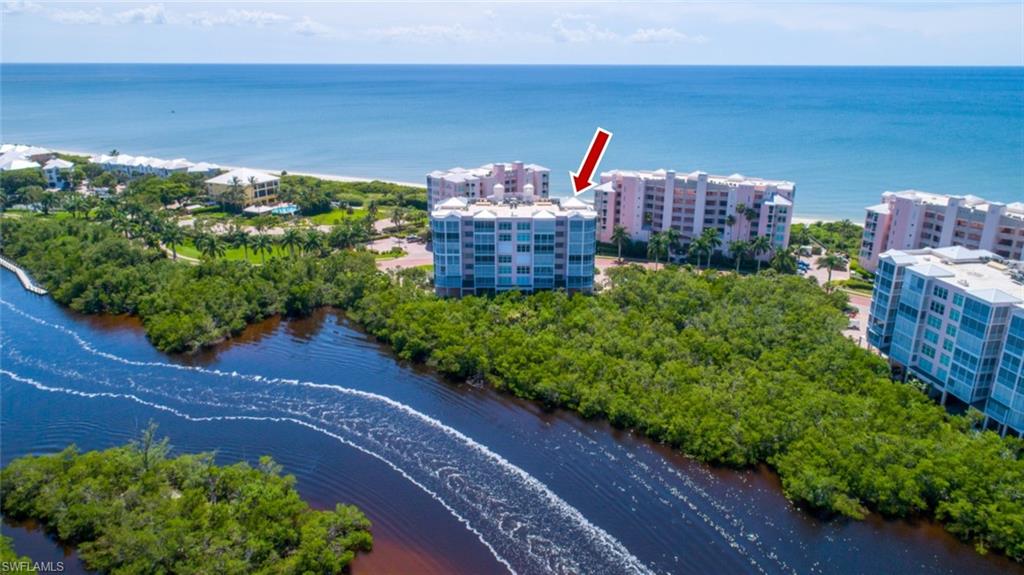 STUNNING, coastal contemporary delight fully renovated & move-in-ready with sweeping Bay views. Enjoy morning sunrises on your Bayfront lanai watching boats cruise by & dolphin splashing in the Back Bay. Then, from a bistro table in your foyer beyond your front door, watch the sunset over the Gulf of Mexico just across the Blvd. Steps to deeded beach access for Barefoot Beach residents & the optional premier “Club at Barefoot.” New driftwood-style plank tile floors & a soothing cool paint color palette highlight the gorgeous kitchen/bath renovations. The renovated kitchen offers white gray honed granite counters, subway tile back splash, crisp white cabinetry with custom pull-outs & custom extended wet bar. Both baths renovated with granite counters, custom cabinetry, slate wood-look tile floors & shower walls, frameless shower enclosure & more. COMING SOON: Brand-new clubhouse with state-of-the-art beachfront fitness center, beachfront swimming pool & community room. Barefoot Beach residents enjoy 3 miles of beachfront, 2 pools/spas, manned/gated entry & on-site mgmt. Excellent North Naples, Collier County location minutes to Mercato, Waterside Shops & easy access to RSW Airport.