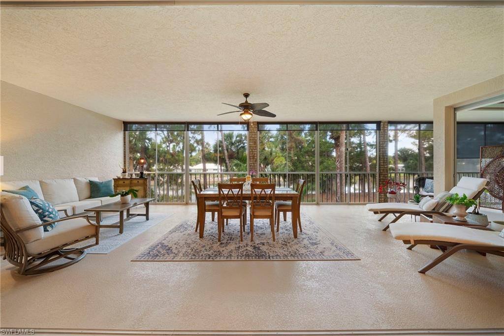 Enjoy immediate access to Eagle Creek's coveted GOLF IN WAITING PROGRAM while embracing one of Naples' most active and welcoming private golf and lifestyle communities. This beautifully updated second-floor condominium offers 2,050 square feet of thoughtfully designed living space with sweeping southwestern lake views and a fully enclosed 16' x 43' lanai with vinyl sliders, creating an expansive year-round living area. Over $80,000 in upgrades include beautifully remodeled en-suite bathrooms, hardwood flooring in both bedrooms, porcelain tile throughout the main living areas, and designer furnishings. A versatile floor plan with the Master bedroom  thoughtfully separated from the Guest bedroom. The updated kitchen features granite countertops, white cabinetry, under-cabinet lighting, a pantry, breakfast bar, and generous workspace for entertaining. Additional highlights include a private one-car garage, separate storage unit, and elevator access. Residents enjoy a newly renovated clubhouse, 18 hole championship golf course, a driving range, short-game practice area and putting green, five pristine Har-Tru tennis courts, six pickleball courts by the upcoming season, three bocce courts, a Junior Olympic-size swimming pool, a state-of-the-art fitness center, an inviting bar with outdoor lakeside dining, and live entertainment overlooking the lake throughout the season—all just minutes from downtown Naples and Marco Island.