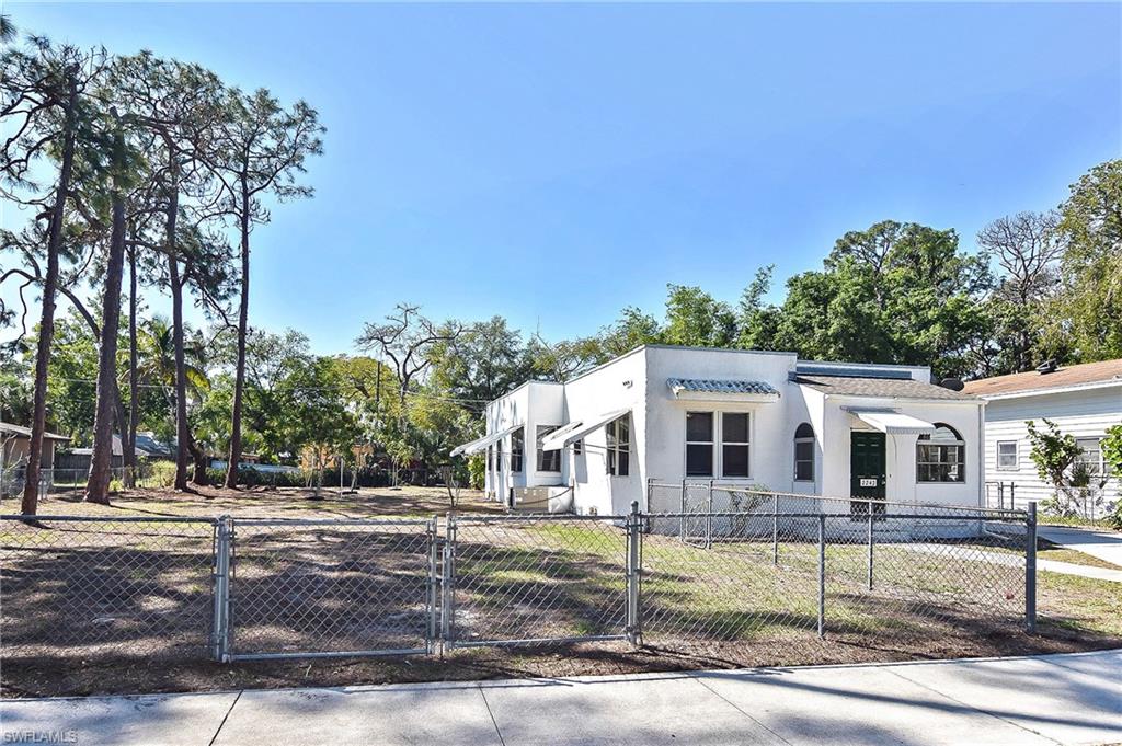 This charming, historic Olde Florida bungalow is a must-see! Sitting on a huge fenced Double Lot in the heart of sunny Fort Myers, this well-maintained home and newer detached 2 car garage and workshop are ready to be called Home. This 3 Bedroom, 2 Bath Home has original wood floors along with a living room fireplace. There is a fenced, covered carport in addition to the beautiful detached garage. Newer Roof, newer hot water heater, newer HVAC. Come by and see it today!
