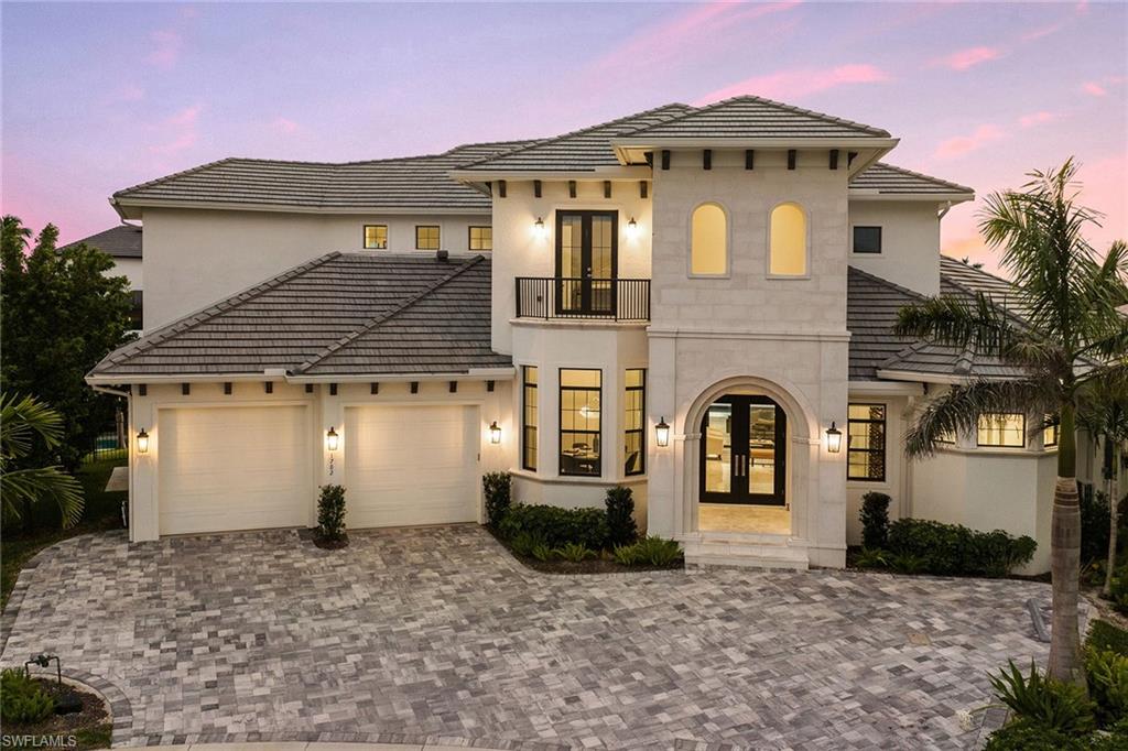 Absolutely stunning RK Reiman-built home with incredible southwestern views! Custom built in 2020, this " like new" home will not disappoint. 5 bedrooms, 6 full baths, den, media room and incredible wine room. Boasting over 4,600 square feet under air, over 7,100 total square feet. Soaring 13' ceilings from the moment you walk in. Open-concept floor plan with great room, living room and separate dining area. Enter the foyer with beautiful wood and glass doors, incredible climate-controlled wine room that hold over 650 bottles of wine, and striking dining area with spectacular crystal chandelier. Porcelain and wood flooring throughout, 2-story elevator, oversized master suite with custom closets, and stunning master bath. Dream kitchen with water views boasts Thermador appliances, quartz counters, custom cabinets and lighting. Massive tiered outdoor living area includes 80' dock with retractable jet ski lifts and 20K boat lift. Huge lanai complete with screens and shutters, outdoor kitchen, bar, sitting area and fire pit. Upstairs open lanai off game room/media room with beautiful sunsets year round. Jaw-dropping one-of-a-kind family home being sold furnished for your convenience!