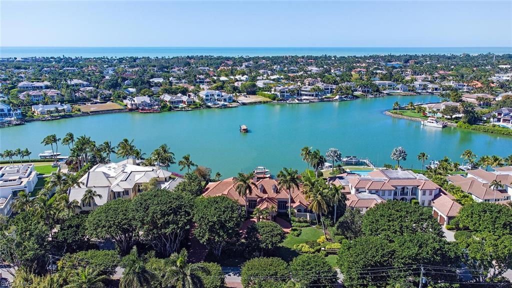 Boaters paradise! Enjoy outstanding panoramic wide water views with 153 ft. of water frontage. This exceptionally well maintained property is perfect for entertaining. The open floor plan encompasses multiple living areas that flow seamlessly from the indoor space to the expansive outdoor living areas including lanai with a retractable screen and gorgeous resort style pool. This custom residence is ready for your design and finishing touches to create your dream home. This desirable property is finished with a pristine dock with boat lift and jet ski lift.  Ideally located in prestigious Port Royal in just minutes from 3rd Street South’s and 5th Avenue South's fine dining, world-class shopping and white-sand beaches.  Port Royal Club membership eligibility.