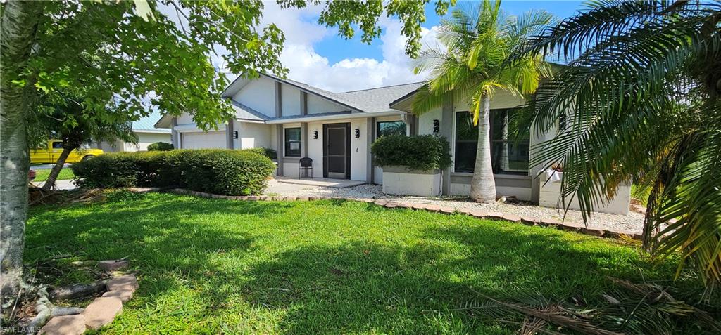 Beautiful 4 Bed 2 Bath Home with Spacious Layout and Gorgeous Design in Quiet Country Club SE Cape Coral Neighborhood. Home Features a Newer Roof (2022), Plumbing (2021) and Water Heater (2023). Tile and Laminate Flooring Throughout the Home, No Carpet. Home has Cathedral Ceilings with Faux Wood Beams for a Unique Look and Plantation Shutters on Every Window. Every Window is Protected by Kevlar Screens or Accordion Shutters. The Grand Kitchen has Shaker Wood Cabinets with Upper-Level Granite, Stainless Steel Appliance Package, Pendulum Lights and Chair Rail. Custom Granite Built In Table in Dining Area Adds a Diverse Feature. Both Bathrooms Have Been Remodeled with Shaker Wood Vanities, Upgraded Tile and High-Level Granite. Master is Larger Than Most with a Significant Master Closet. The Garage has Extra Depth and a Motorized Screen to Keep the Pests Out. The Outside Area is Just as Updated and Unique. Ther Lanai Area Under Truss is Perfect for Family Get Togethers and BBQ's and Even More Space in the Screened Area Around the Electric Heated Freshly Resurfaced Oversized Pool. The Whole Lanai Area and Driveway is Stamped Concrete to give it a Classy Look. If That is Not Enough, The Fenced In Yard and Mature Landscaping Makes for a Tropical Paradise. This is a Must See!!!!