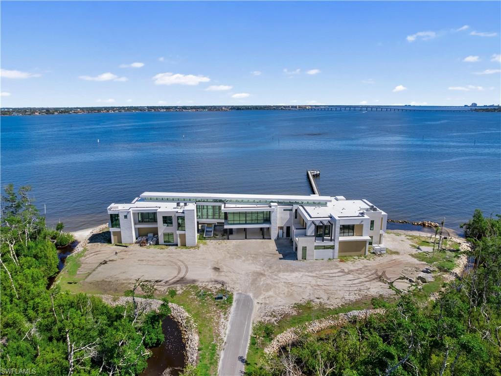 "Sale reflects property-specific conditions and is not indicative of market value." This estate is one of the most amazing luxury estate opportunities ever introduced in Lee County, this extraordinary waterfront property offers the foundation for a truly iconic residence. 31+ acres crowning the most commanding point of a private escape along the Caloosahatchee River. The site boasts over 1,500 feet of shoreline with sweeping water views in both directions and a level of scale, privacy, and natural beauty that is increasingly rare in Southwest Florida. The estate is approached via a private, gated entrance and a 1,500-foot drive, winding through mature tropical foliage and tidal inlets that naturally buffer the property from the outside world. The setting was carefully selected for those whose lifestyle demands absolute privacy, security, and discretion, while still offering direct access to open water, nearby islands, and regional ports. Designed as the future home of architectural significance, the property supports a residence of substantial scale and presence, with site planning that maximizes water frontage, view corridors, and the daily movement of light across the landscape. A 380-foot dock near the mouth of the river provides exceptional boating access, while the expansive acreage allows for additional features such as guest structures, recreational amenities, or aviation accommodations, including a potential helipad-ready site. This is not simply a homesite, it is a legacy property, offering a rare opportunity to create an estate of enduring value on one of the most compelling waterfront parcels in the region.