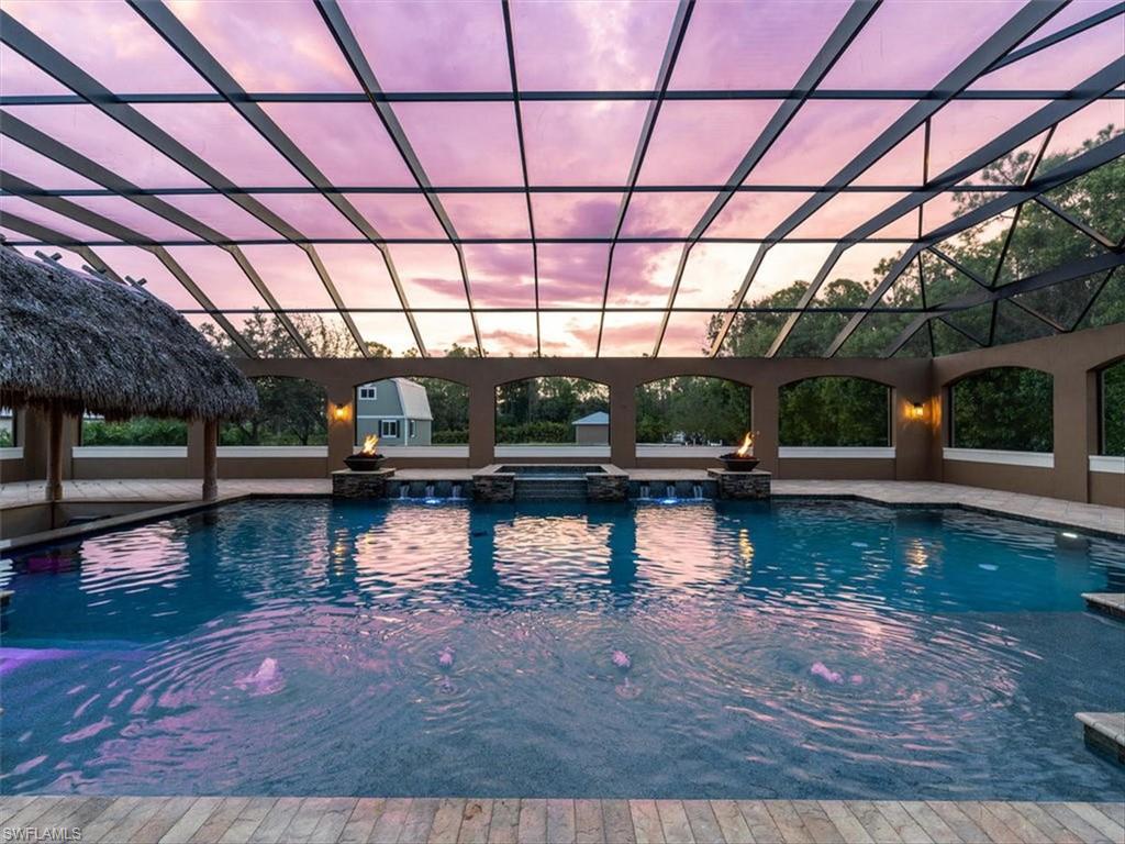 This ULTIMATE estate home awaits you with unrivaled outdoor living & privacy, yet still convenient to high-end shopping, restaurants & top-rated schools all within minutes of the beach! Your indoor/outdoor oasis comes complete with a 5,000 sqft screened rear lanai enclosure, custom 45’ pool, 6-person spa, swim-up Chickee bar, summer kitchen & fireplace. Interior features include a gourmet kitchen, great room, library/den/study, game room, first floor master suite, additional first floor master/guest suite & loft. The chef and host in you will enjoy the expansive kitchen complete with 2 islands, Wolf gas range, 2 electric wall ovens, refrigerators, dishwashers, wine fridge & large walk-in pantry. Commercial grade whole-house generator, reverse osmosis water system & laundry on 1st & 2nd floors ensure comfort & convenience. Equipped with newer AC Units & Water Heater! Outbuilding with power is ready to be finished as a custom office, she shed, man cave or workshop! Perfectly situated on 2.26 acres with close proximity to shopping, hospitals, top-rated schools, and less than 5 miles to Gulf beaches and the high-end retail stores & fine dining of Mercato & Waterside Shops.