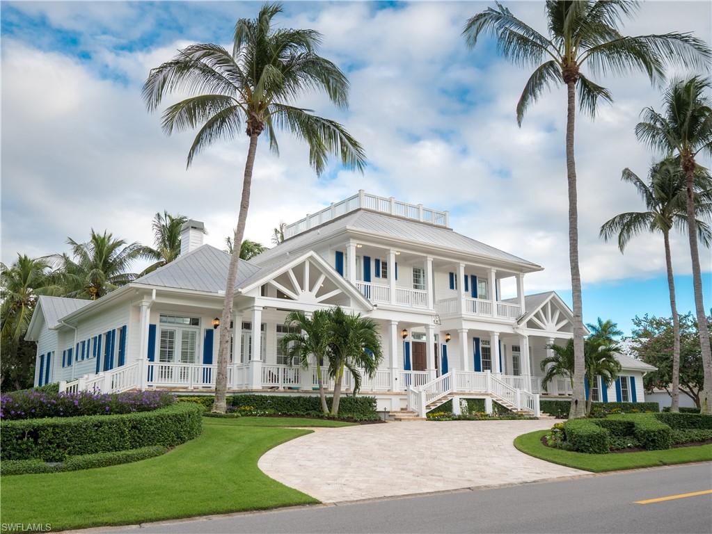 Gables by the Sea - Revel in the charm of this timeless two-story gable inspired architecture with manicured lawns, beautiful flowers & circular drive.  The sweeping floor plan features a welcoming entry leading to an expansive great room with custom fireplace & separate office.  The first floor primary bedroom with French doors out to the pool & spa includes spacious walk-in closet, separate walk-in shower & soaking tub. All three upstairs bedrooms have a private bathroom & balcony. This highly desirable home, bathed with natural light throughout the day, is perfectly situated steps to our award winning sandy beaches & minutes to the acclaimed fine dining & shopping on Third Street South. A perfect retreat, this home provides for privacy for the owner, as well as guests, having a guest suite, which overlooks the tranquil courtyard filled with brightly colored plants. Entertain family & friends in the well equipped kitchen with Sub Zero & Thermador appliances or grill outdoors & dine al-fresco on the patio within the private walled pool & spa. Enjoy the sunset views on the all-embracing front porch with western exposure toward the Gulf of Mexico.
