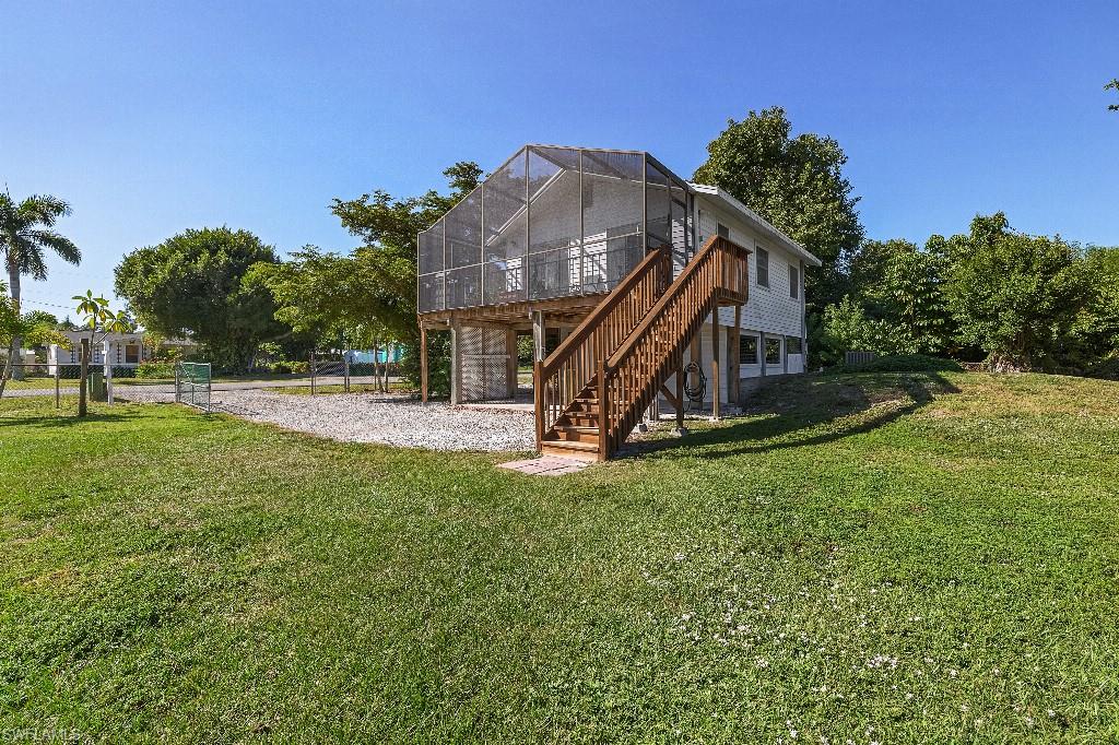Back on the market after Buyer's financing fell through. Experience the quintessential Pine Island lifestyle in this beautifully appointed retreat, where tropical serenity & phenomenal flora & fauna meets modern accessibility. This charming island home is ideally positioned moments from local marinas, dining, shopping, and the island's iconic scenic bike path. The upper level radiates warmth, featuring a sun-drenched living area and two comfortable bedrooms. The kitchen serves as a focal point, elevated by exquisite Portuguese porcelain tile countertops and a matching backsplash. For relaxation, the screened lanai offers a seamless transition to the outdoors to unwind, overlooking peaceful views of lush surroundings; perfect for enjoying your morning coffee or evening cocktails. The lower level provides exceptional flexibility with a private-entrance guest suite, including a third bedroom, half bath, and expansive storage—an ideal setup for an art studio or workshop. With a new roof and water heater (2023), a fully fenced yard, and verdant mature landscaping & fruit trees on two lots, this home is a turnkey slice of paradise.
Don’t wait---paradise is calling!!
