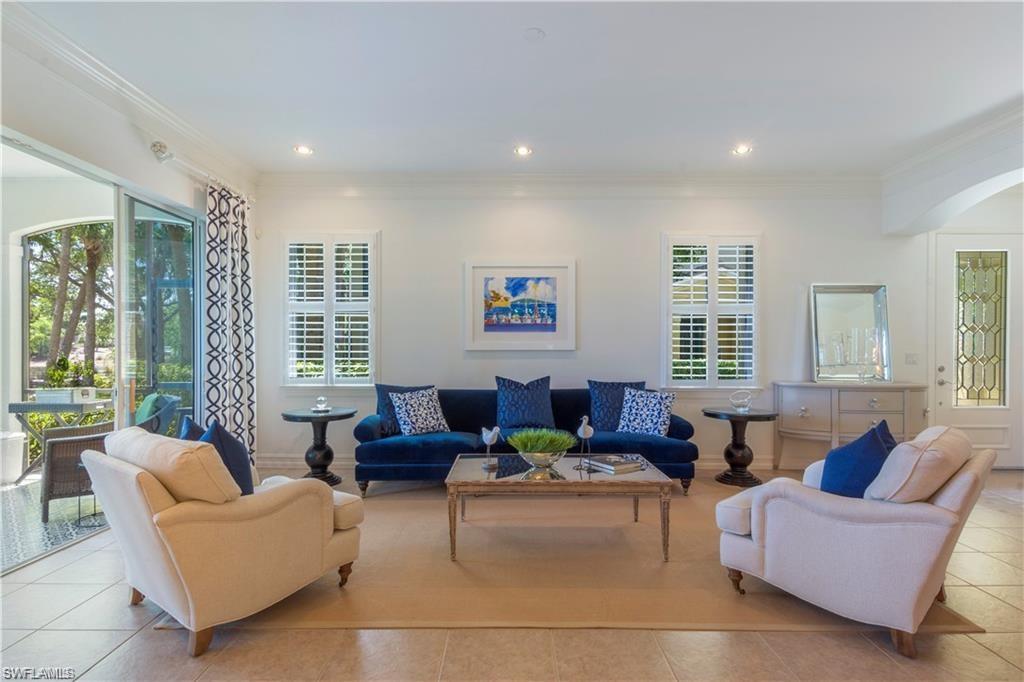 Beautifully decorated 1st floor 2 BR + den condo lives like a single-family home. The east-facing lanai overlooks a lake and the 3rd tee of the Greg Norman Gold Golf Course. A transferable SIGNATURE MEMBERSHIP IS AVAILABLE with your lease which gives you access to the Tiburon clubhouse, tennis, fitness, pro-shop, several dining options, and golf at a reduced rate. Enjoy the Reservoir Water Experience at the Ritz Carlton Golf Resort! This home has plenty of windows and natural light, an over-sized master suite, gorgeous kitchen with white quartz, gas range, all new appliances, and an attached 2 car garage. Walking distance to the community resort- style pool, Tiburon Clubhouse, and the Ritz-Carlton Golf Resort.